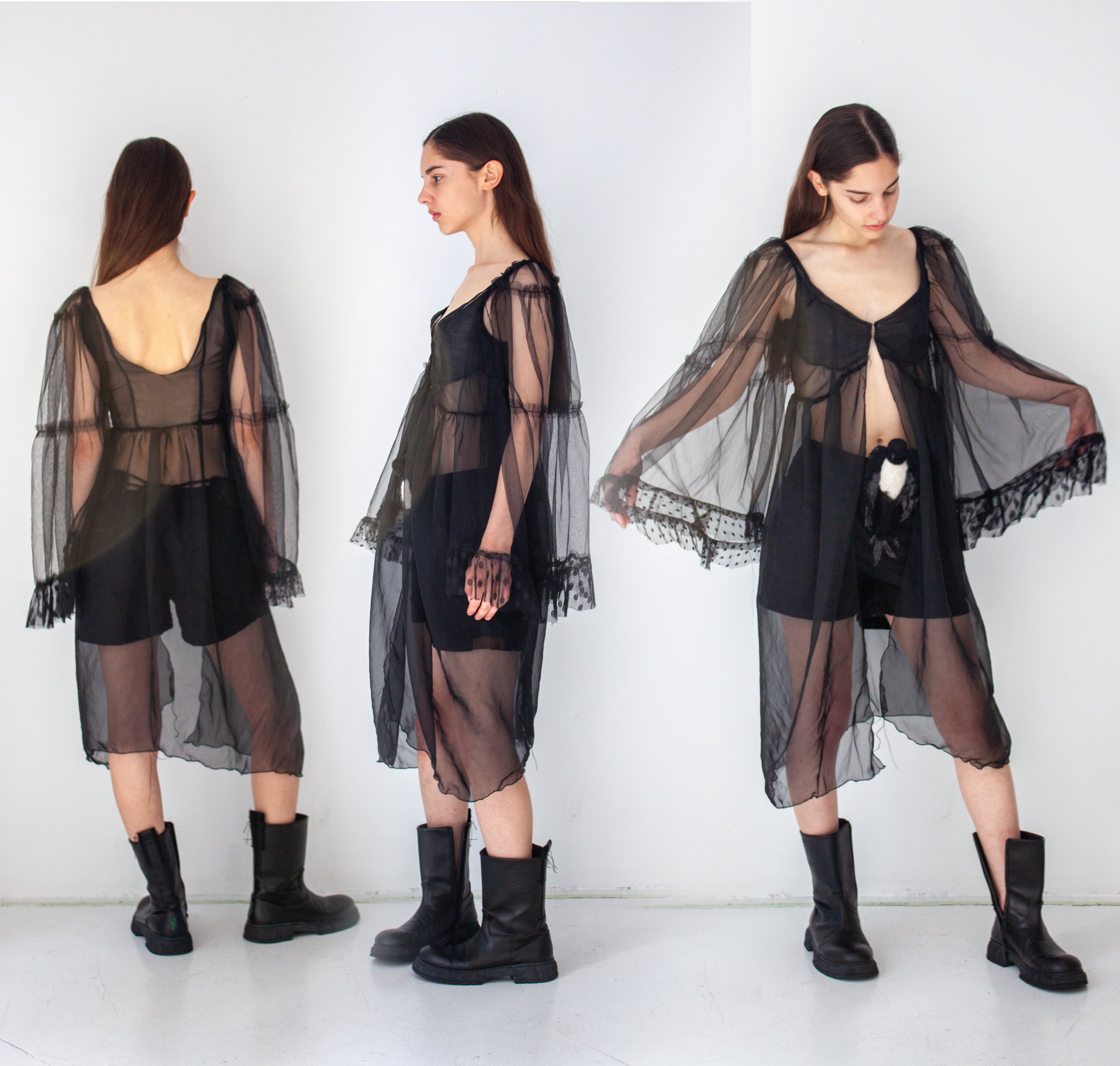 A poly-organza top with multi-tiered wide bell sleeve using multiple types of soft tulle, completely upcyled materials, with front clasp hook and eyes. On the bottom are black cotton  mid-rise mini shorts with a silk satin lining. The belt features a