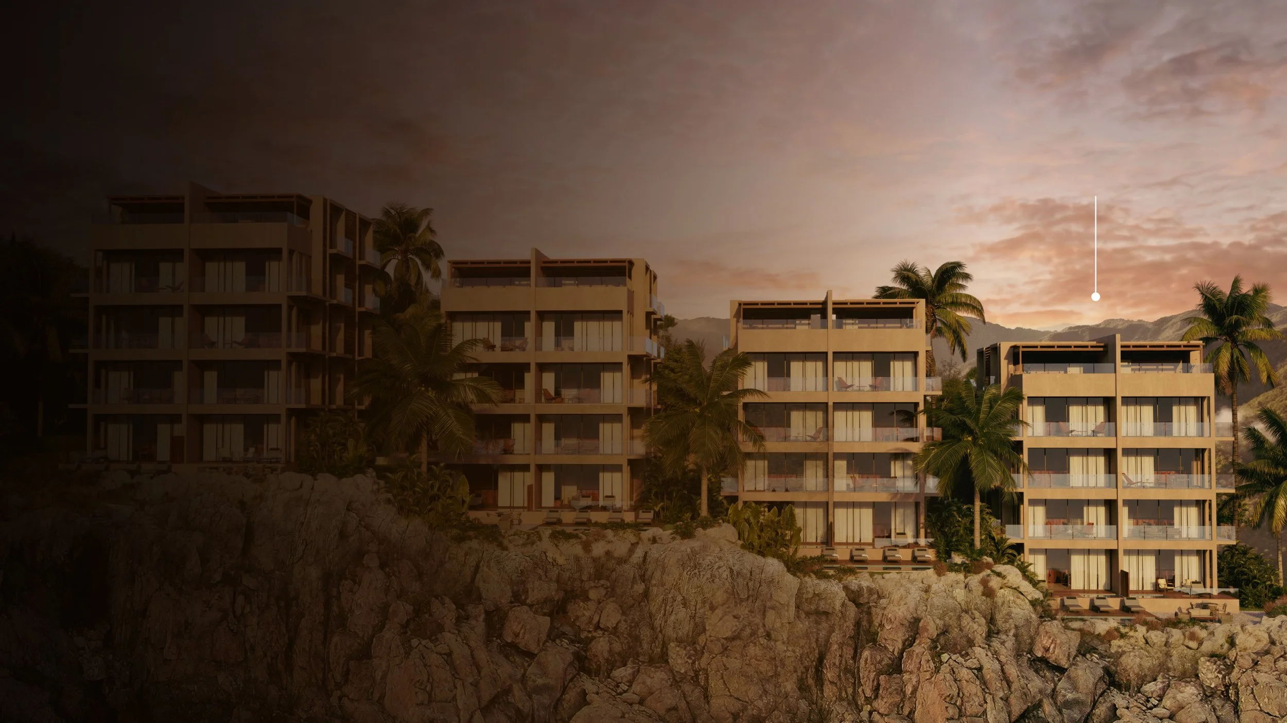 Conjunto de edificios residenciales en una zona costera con palmeras, al atardecer, con montañas al fondo y un cielo parcialmente nublado.