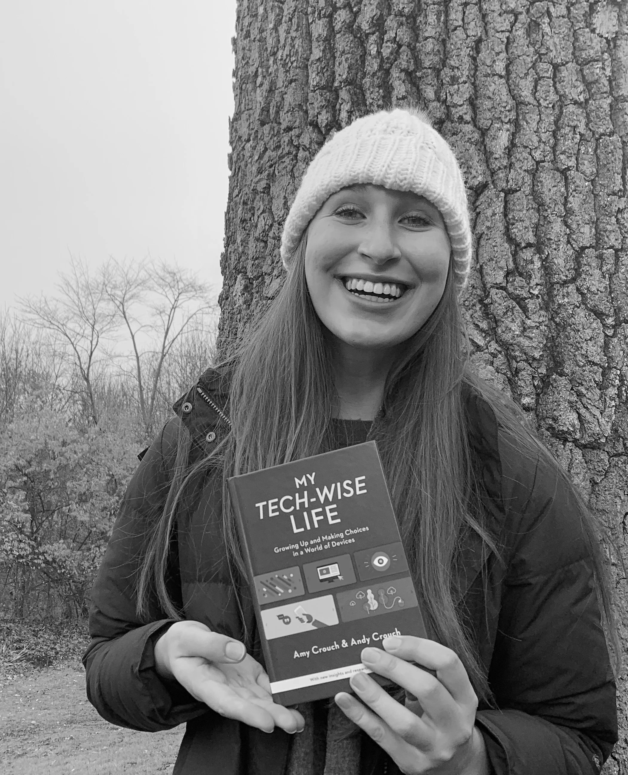 Amy Crouch holding her book, My Tech-Wise Life, smiling because she's a published author.