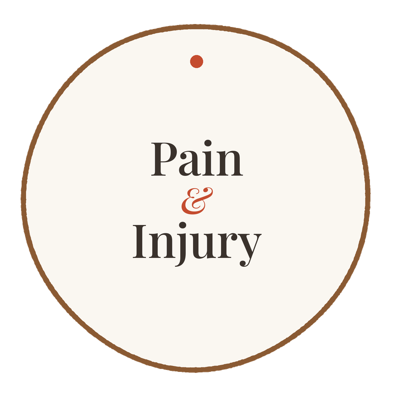A circular sign with a beige background and brown border that features the text 'Pain & Injury' in black and red letters.