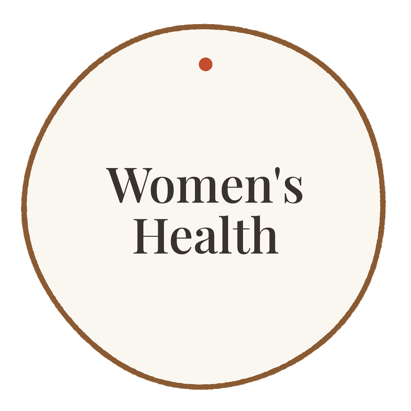 A circular sign with the words "Women’s Health" in black text on a white background, outlined in brown.