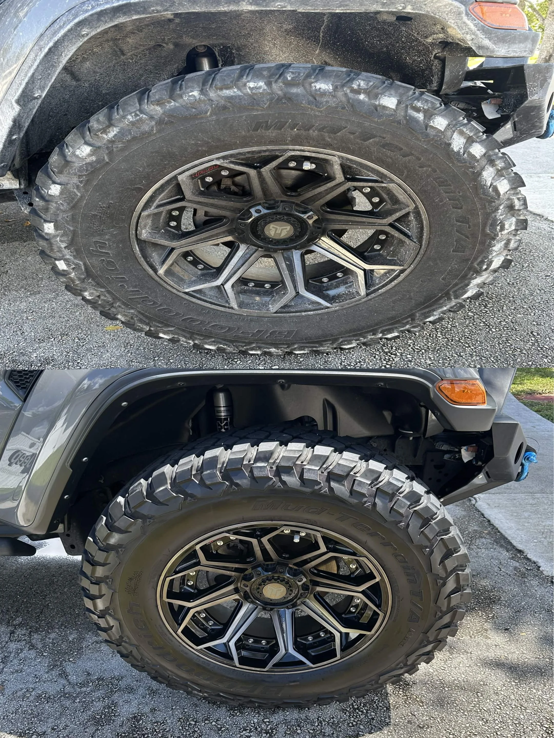 Close-up of two off-road vehicle tires with black alloy wheels, muddy exterior, and rugged tread pattern parked on a paved surface.