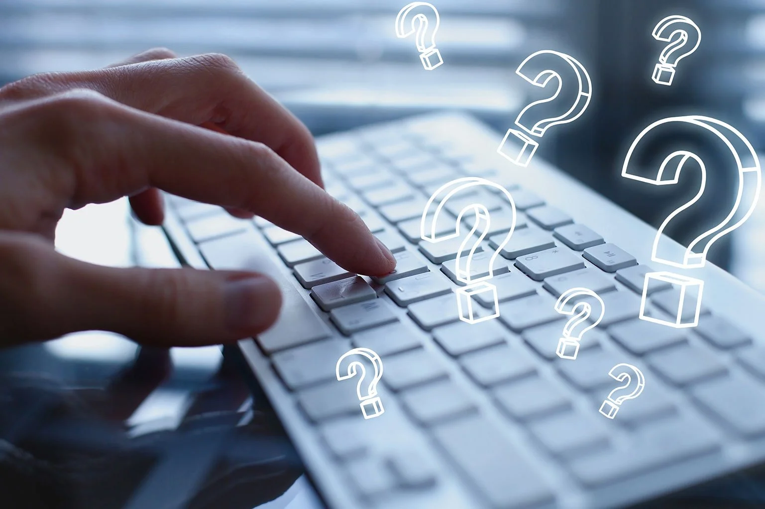 A person typing on a computer keyboard with white question mark icons overlaid, symbolizing questions or uncertainty.