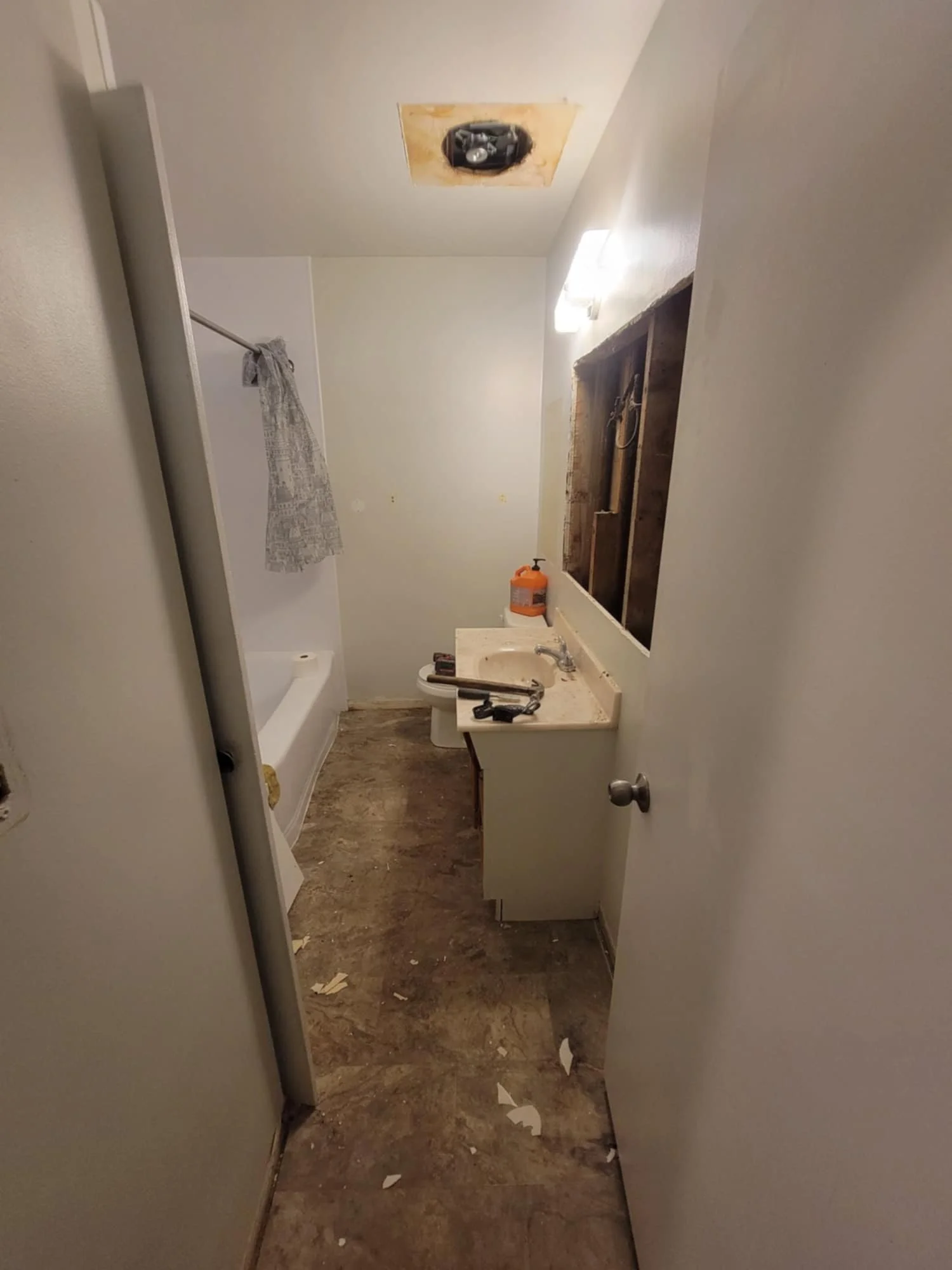 We removed the built-in medicine cabinet. The mirrors were tiny and all peeling, and inside the wall we found a few surprises.