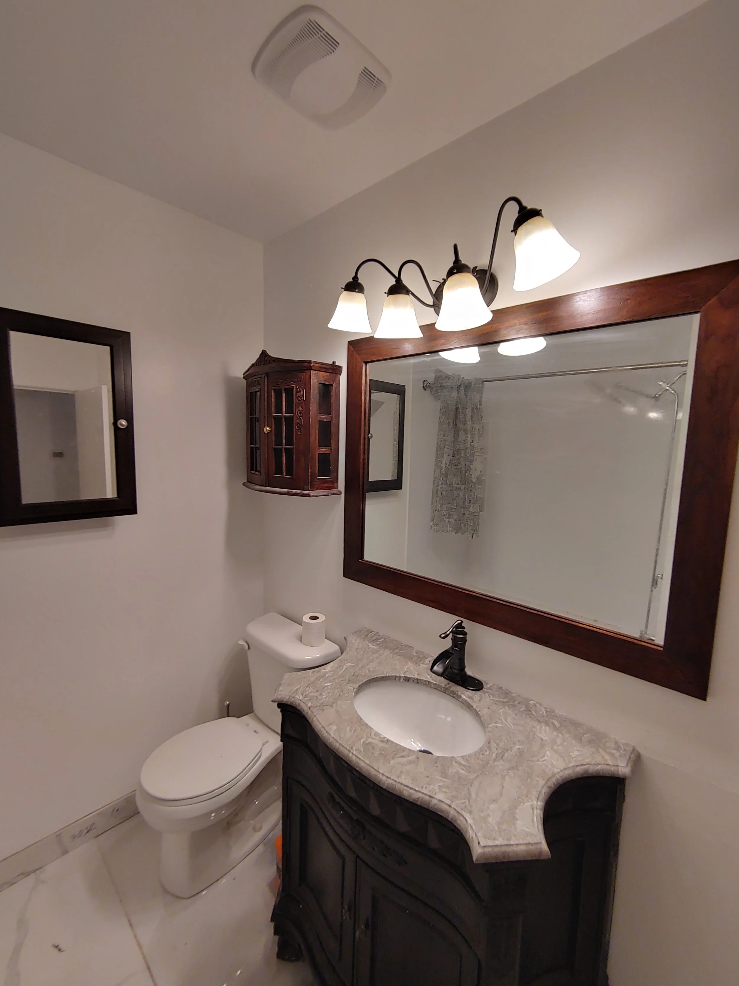 And this is the final result. In this picture we still had a few tasks to do - fan timer and light cover, caulking around the bottom of the tub, but the new vent is there, this time you couldn't see the sky through it, with a lot less noisy fan, new 