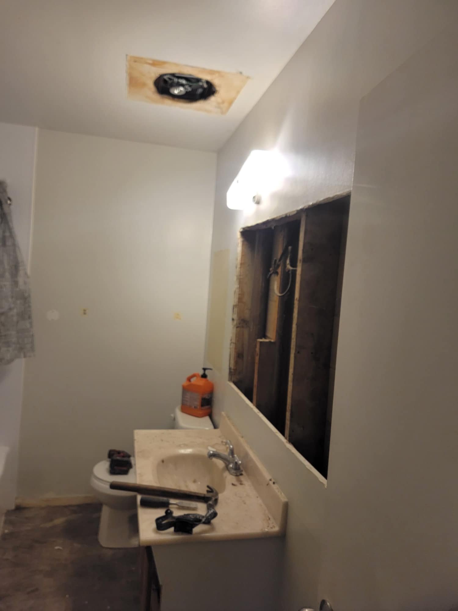 We removed the built-in medicine cabinet. The mirrors were tiny and all peeling, and inside the wall we found a few surprises.
