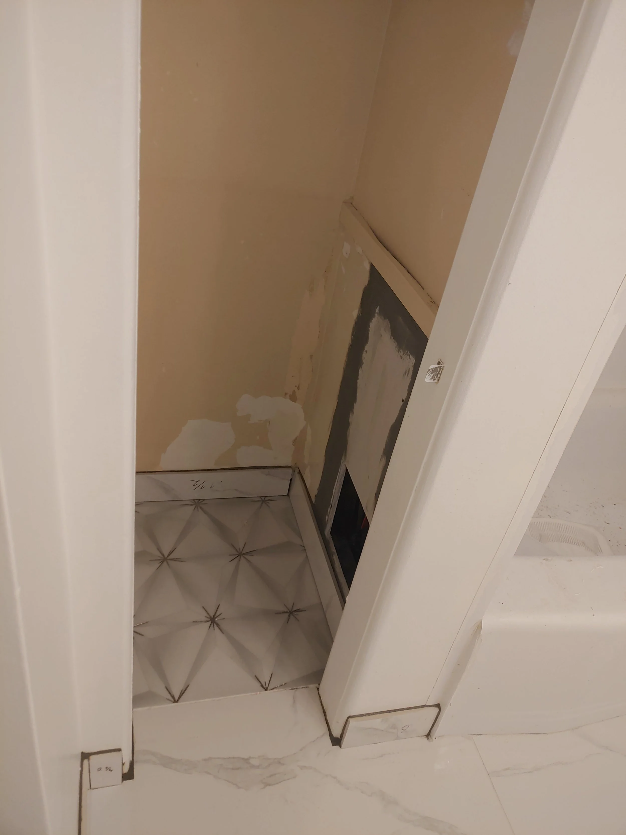 The access to the bath water cut-offs was covered with a piece of plywood. We replaced it with a proper access door and patched the rest of the wall.