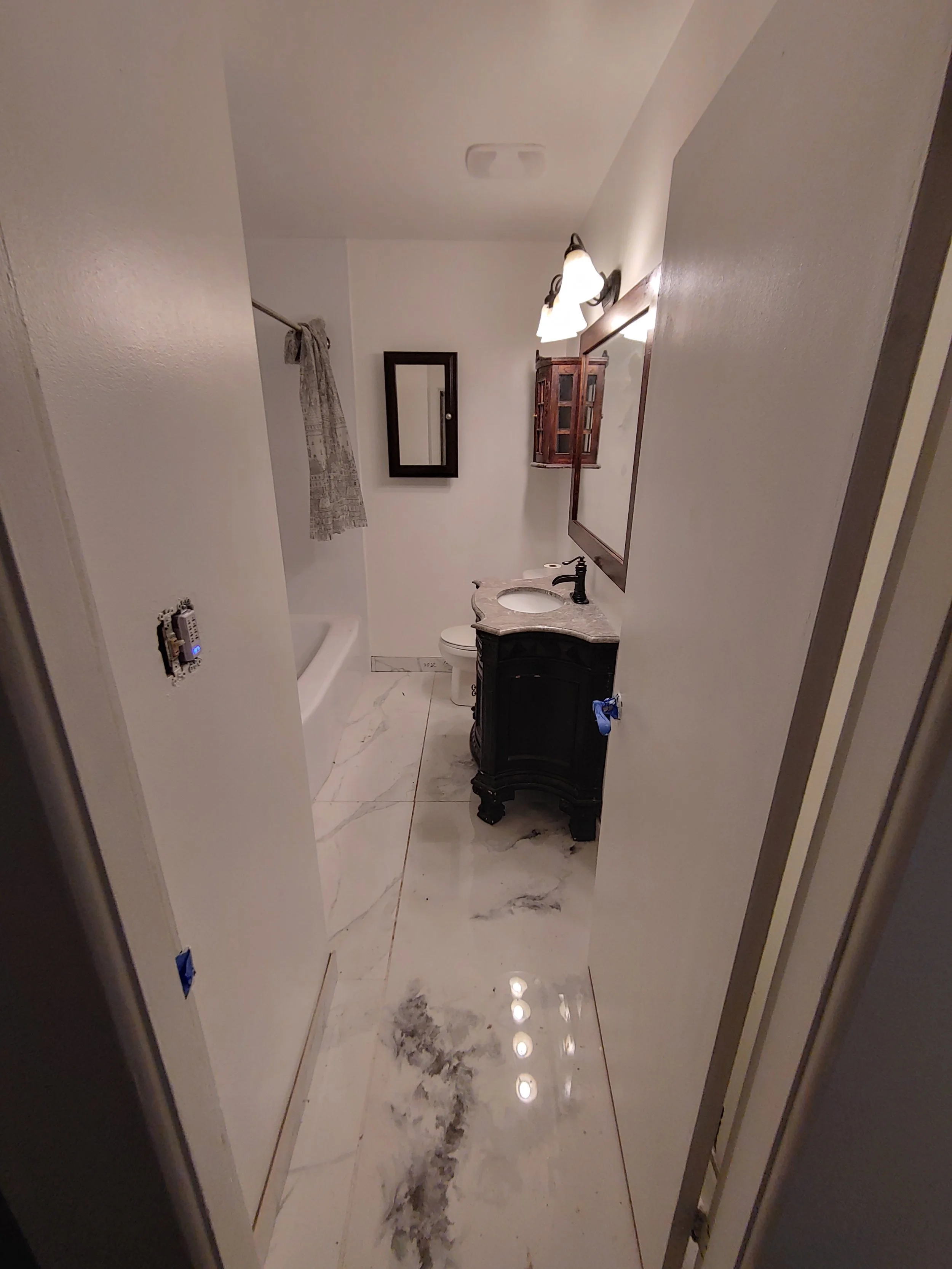 And this is the final result. In this picture we still had a few tasks to do - fan timer and light cover, caulking around the bottom of the tub, but the new vent is there, this time you couldn't see the sky through it, with a lot less noisy fan, new 