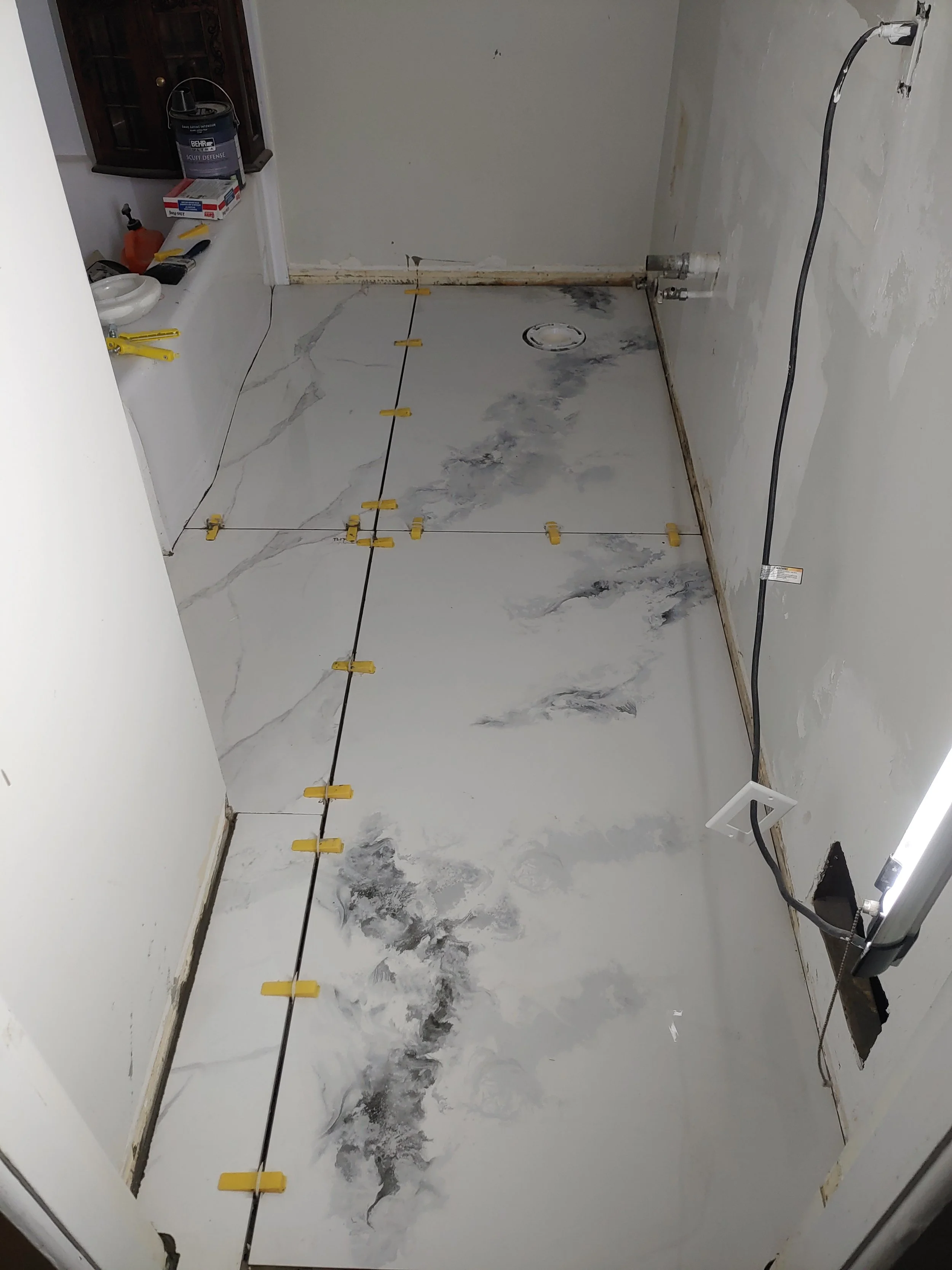 New tiles were absolute must. We poured self leveling compound, then worked the Thinset with the 12mm thick tiles to set them, level them and get them ready for grouting. We also had to compensate for the thickness of the tile with a toilet bowl spac