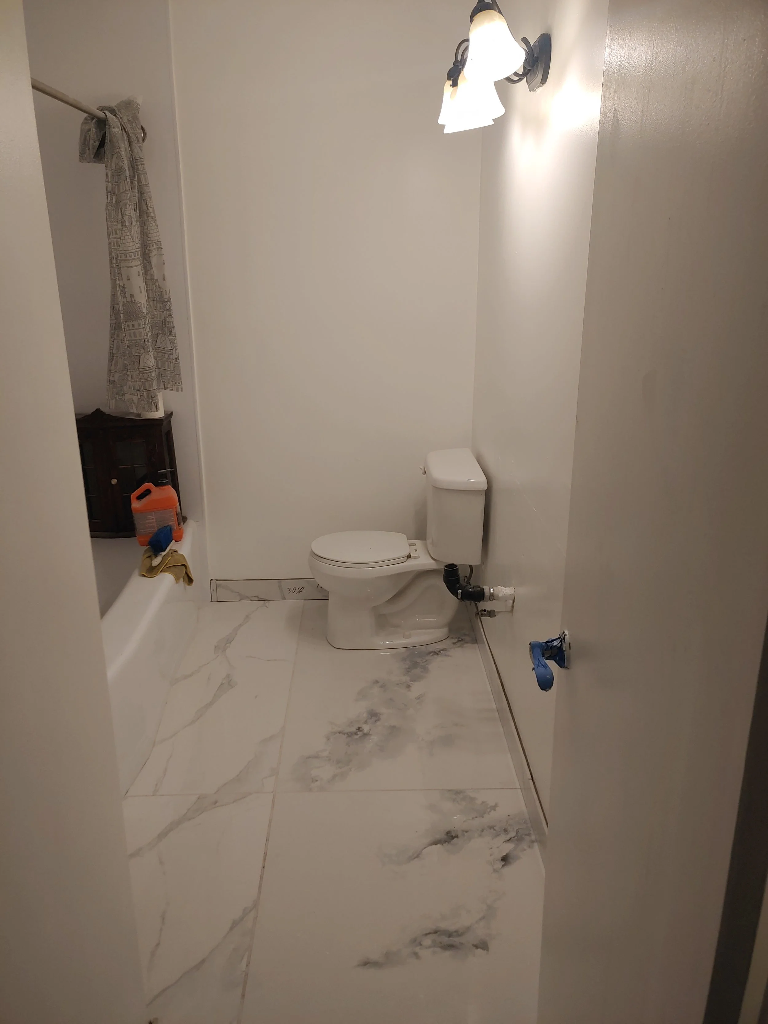 New tiles were absolute must. We poured self leveling compound, then worked the Thinset with the 12mm thick tiles to set them, level them and get them ready for grouting. We also had to compensate for the thickness of the tile with a toilet bowl spac