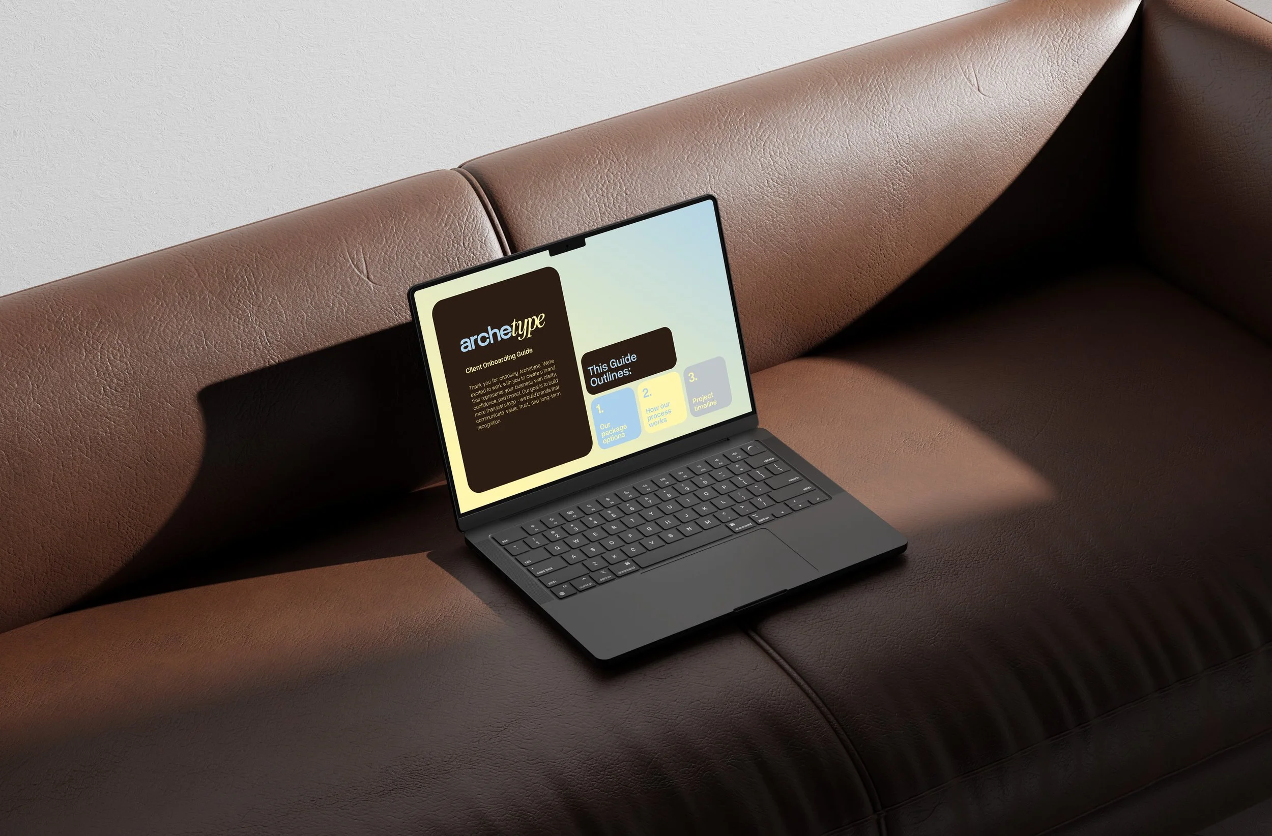 A laptop resting on a brown leather couch displaying a presentation slide titled 'archetype' with outline points.