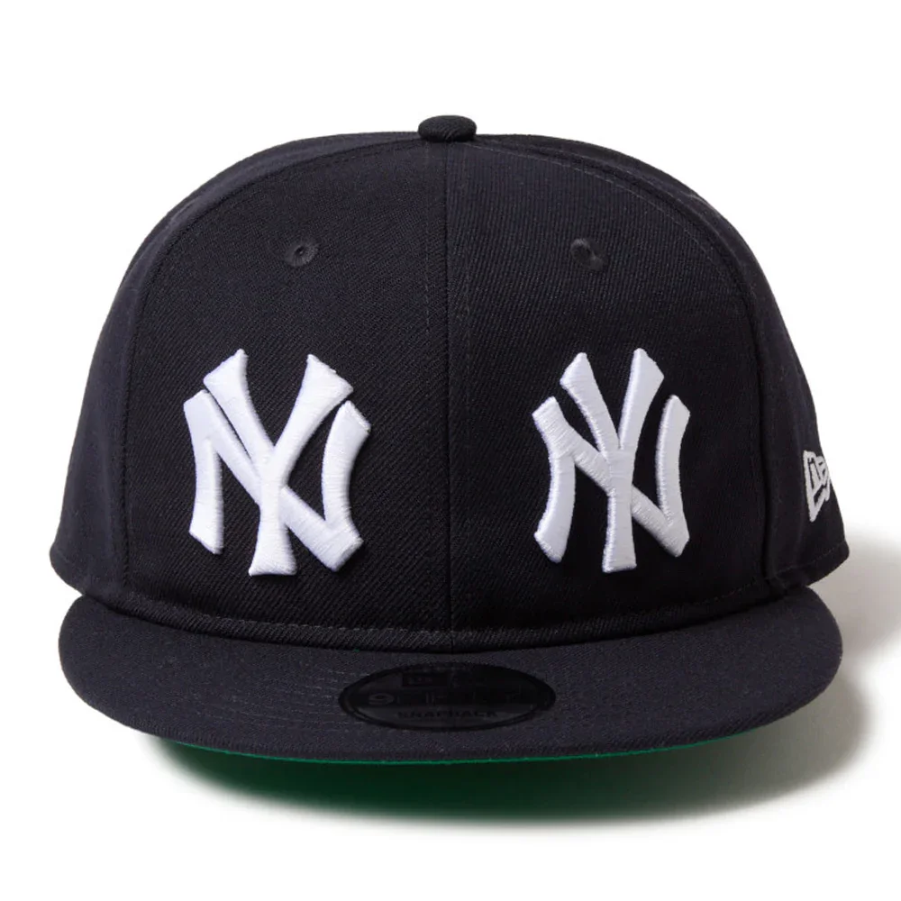 A black New York Yankees baseball cap with white embroidered Yankees logos on the front.