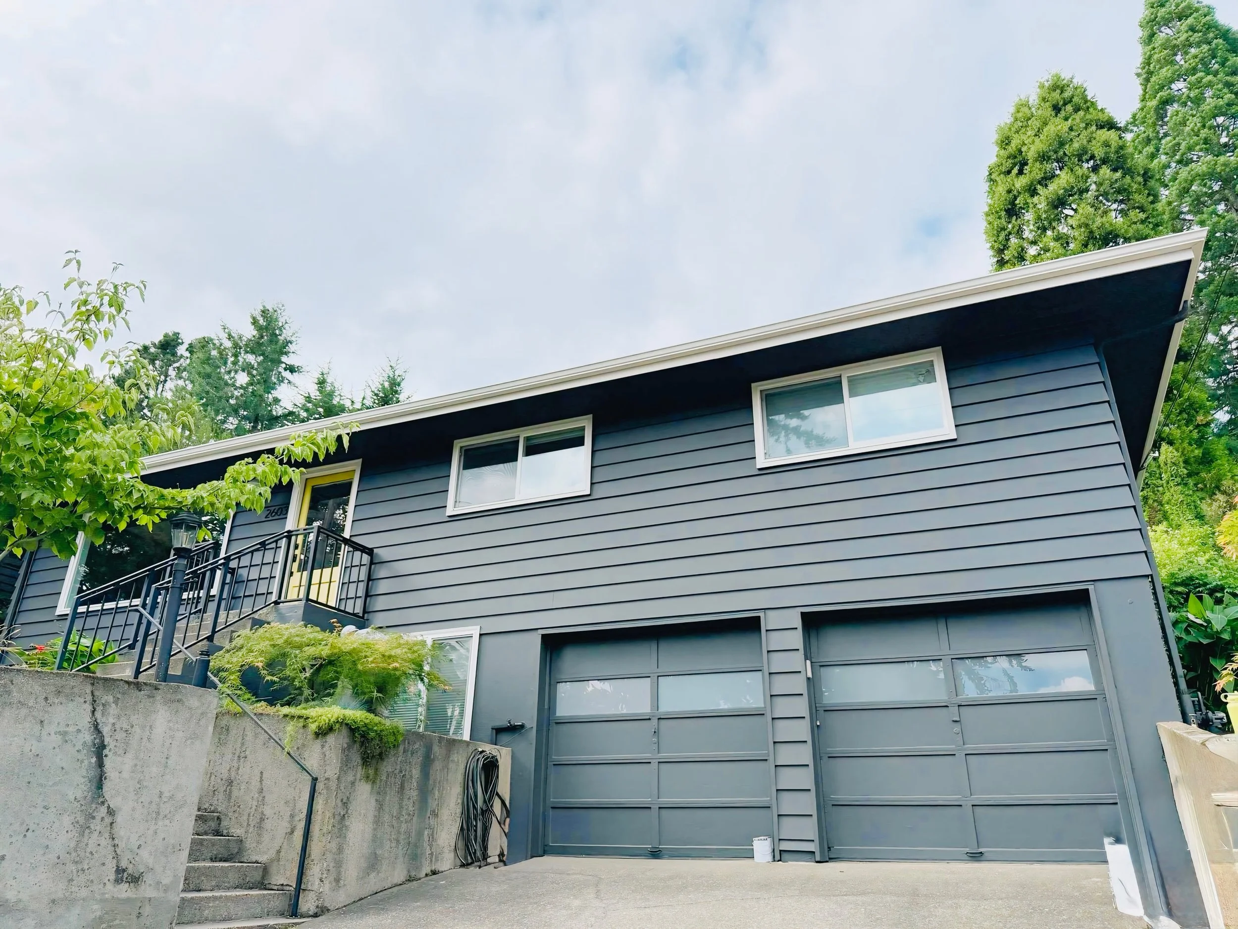 Freshly painted gray exterior on a large two-story Beaverton home, exterior repaint by Cascade Painting