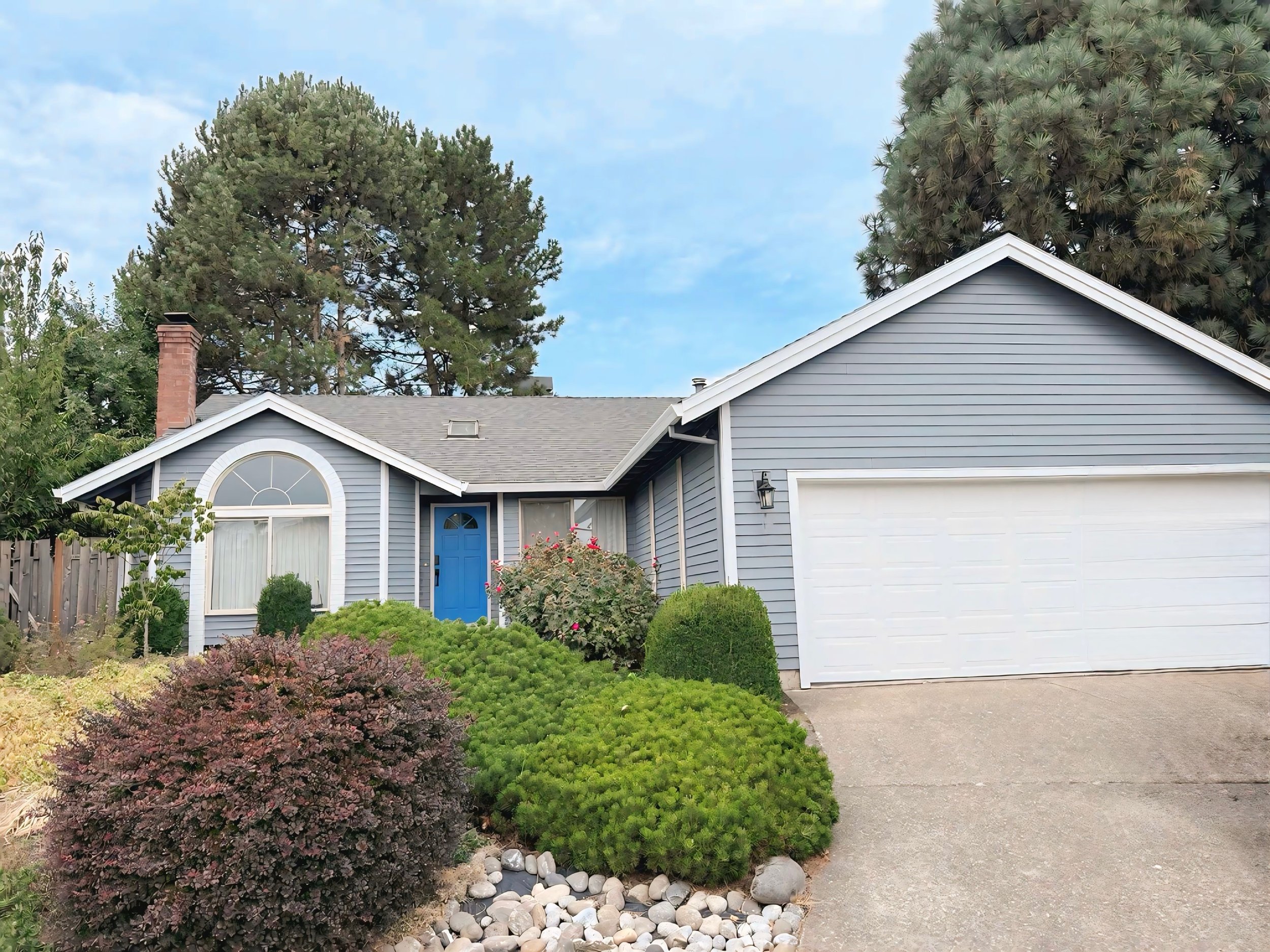 Beaverton home with freshly painted gray siding, white trim, and blue front door, full exterior repaint by Cascade Painting