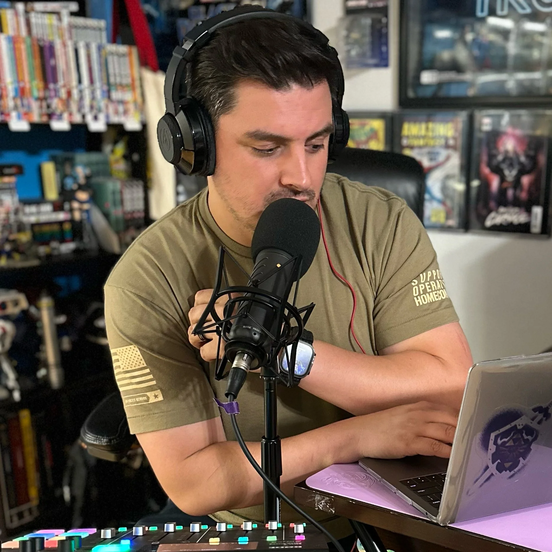 Rick (Link7LP) recording Sigma Duocast podcast using microphone and laptop, surrounded by film, gaming, and pop culture collectibles.