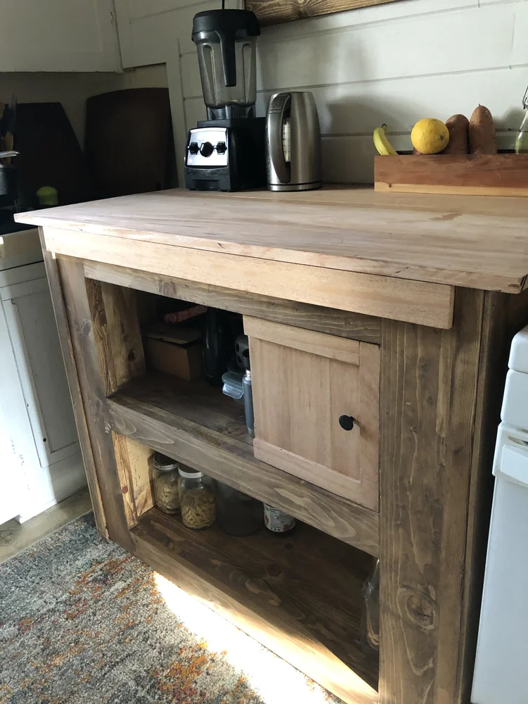 Kitchen counter with open shelves and a mahogany top