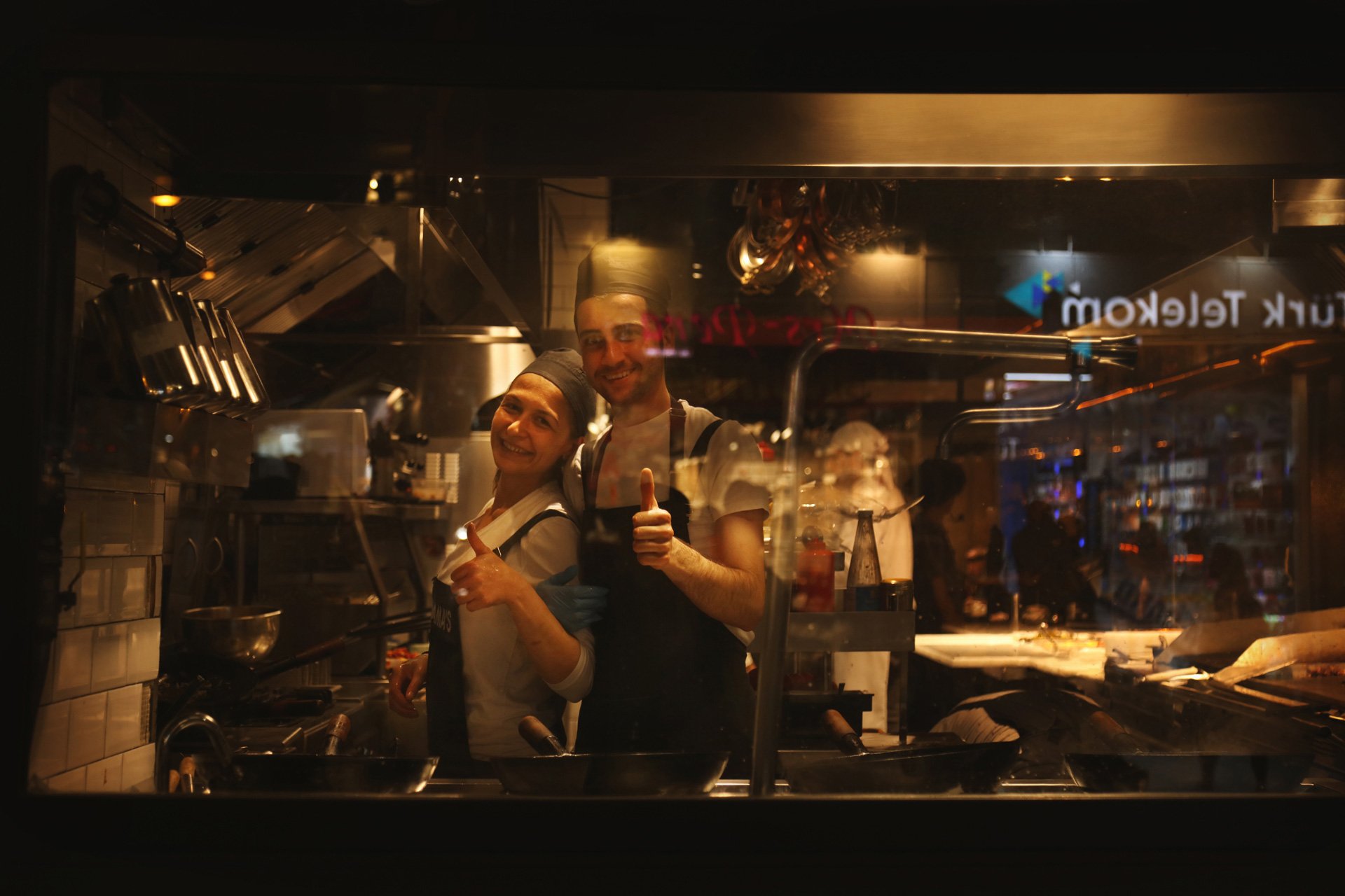 ortrait of young woman and man standing in the restaurant, looking at the camera and smiling, Istiklal Street, Turkey