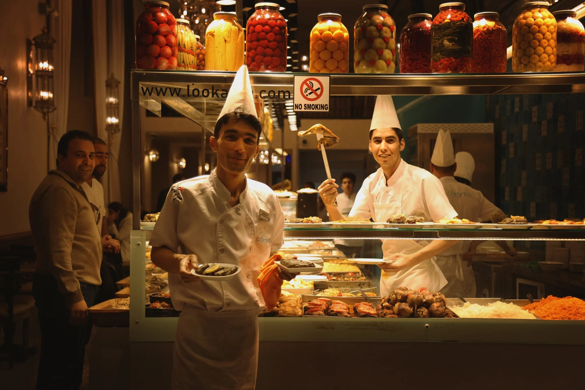 Portrait of young men standing in the restaurant, looking at the camera and smiling, Istiklal Street, Turkey