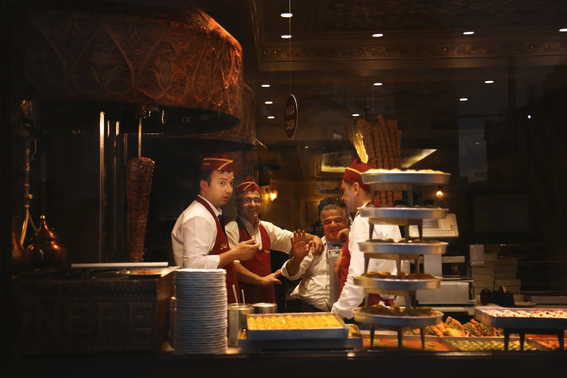A group of men standing in the restaurant, looking at the camera and smiling, Istiklal Street, Turkey