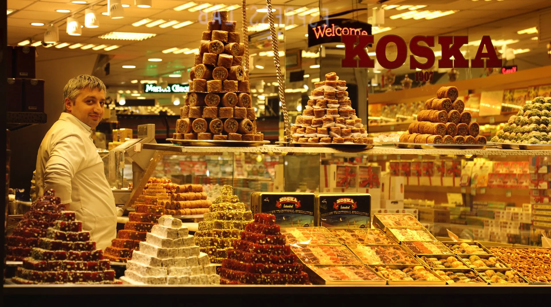 Portrait of a man standing in the confectionery store, looking at camera, Istiklal Street, Turkey