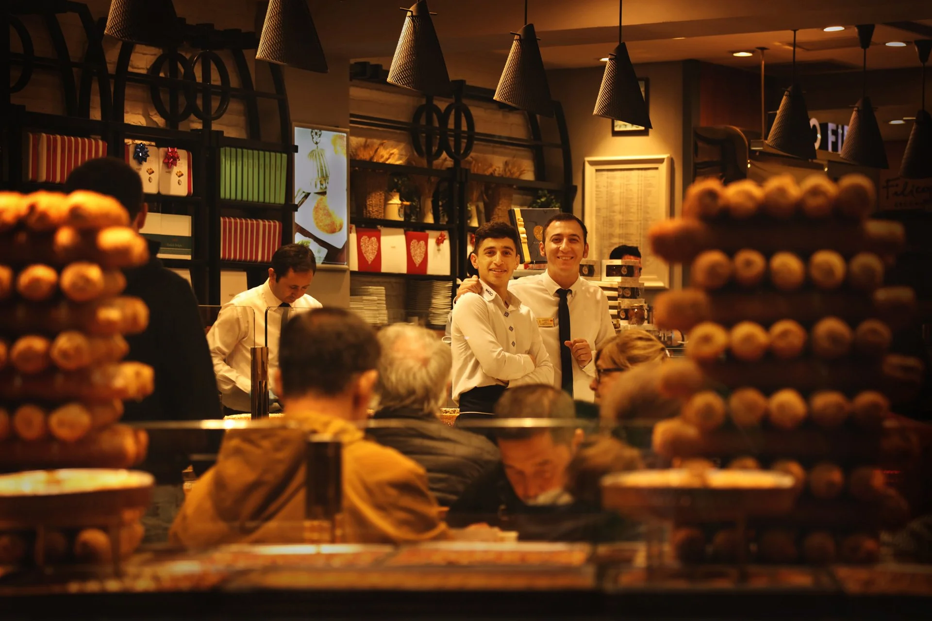 Portrait of young men standing in the confectionery store, looking at the camera and smiling, Istiklal Street, Turkey 