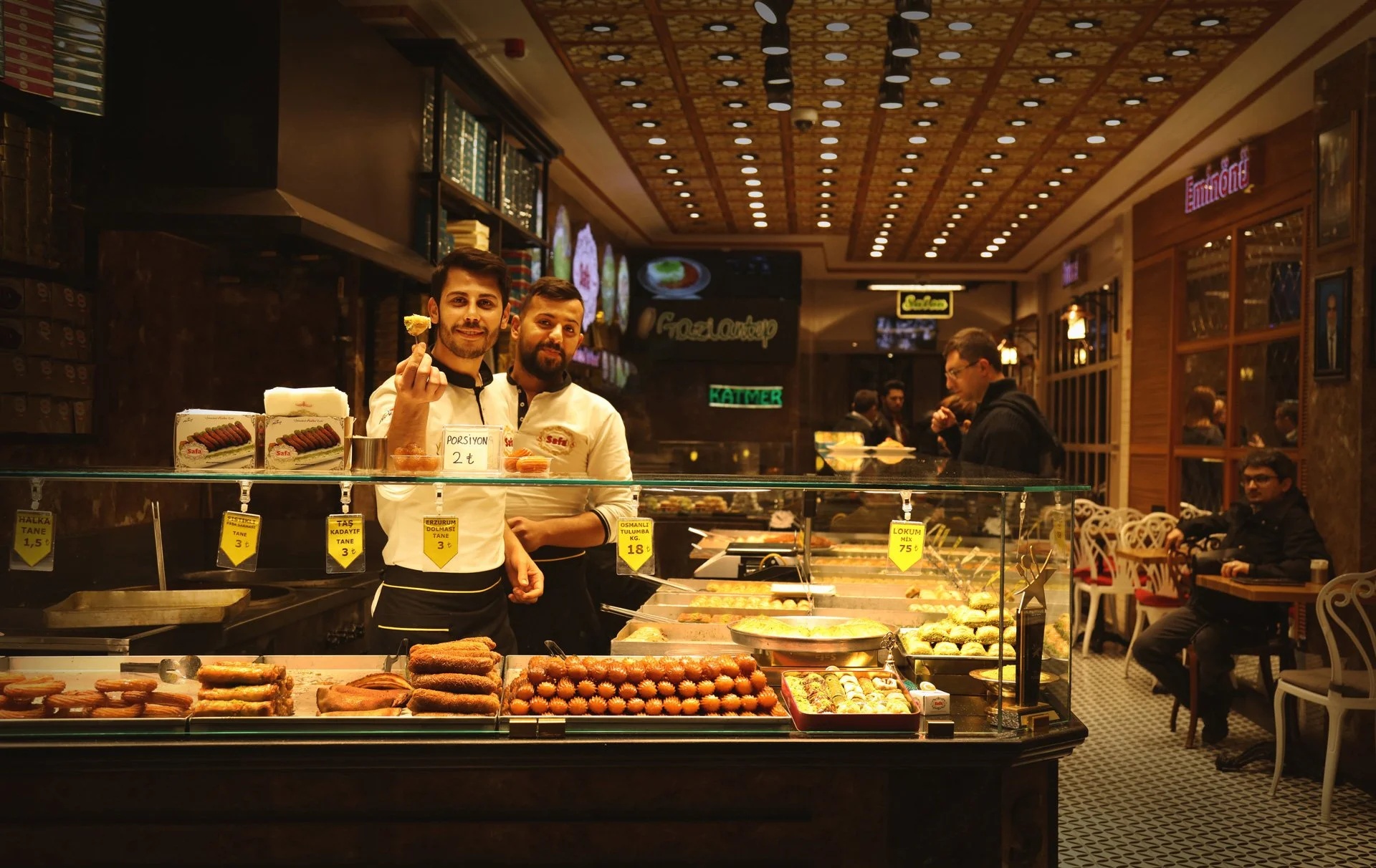 Portrait of young men standing in the confectionery store, looking at the camera and smiling, Istiklal Street, Turkey