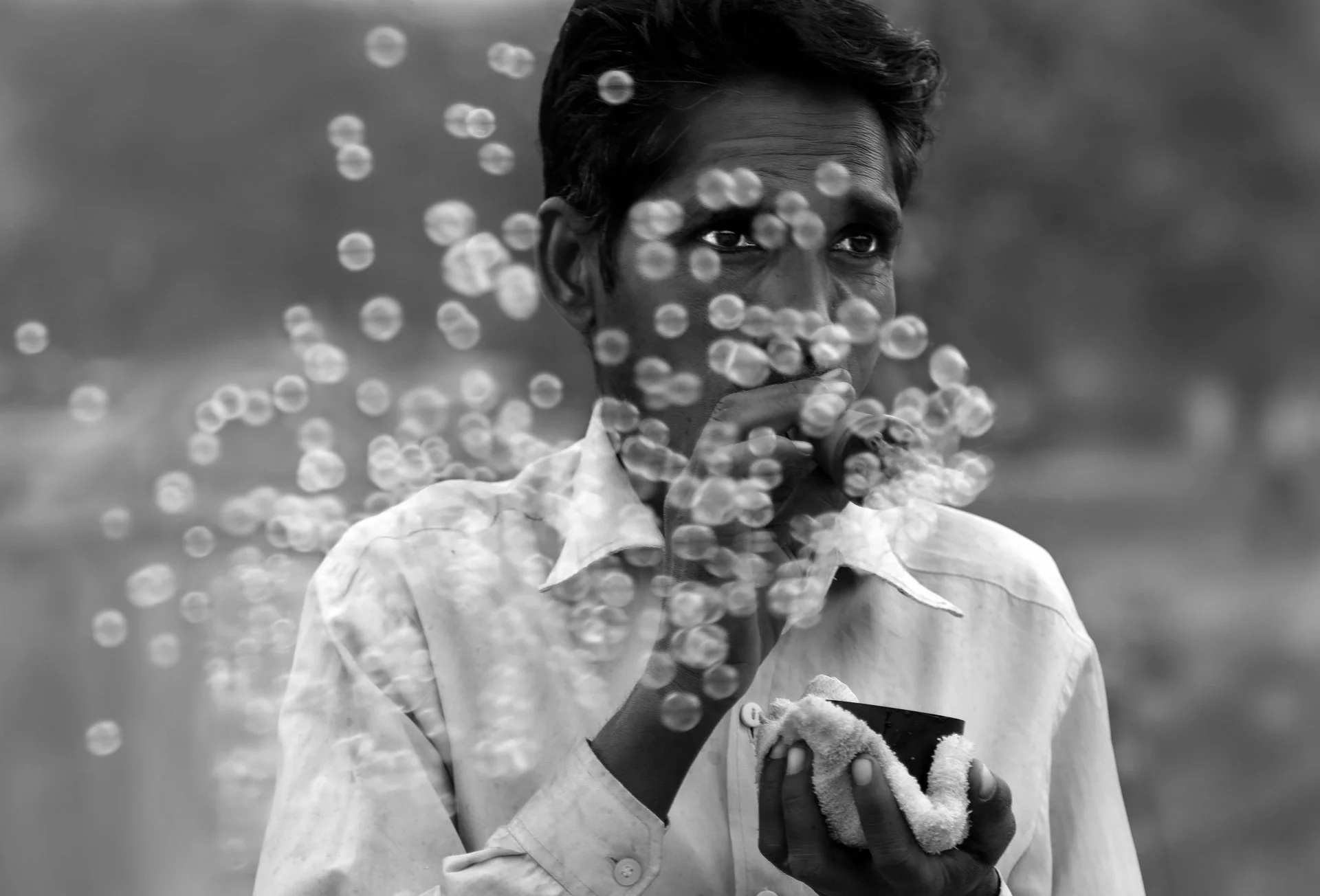 Indian man blowing bubbles in the street