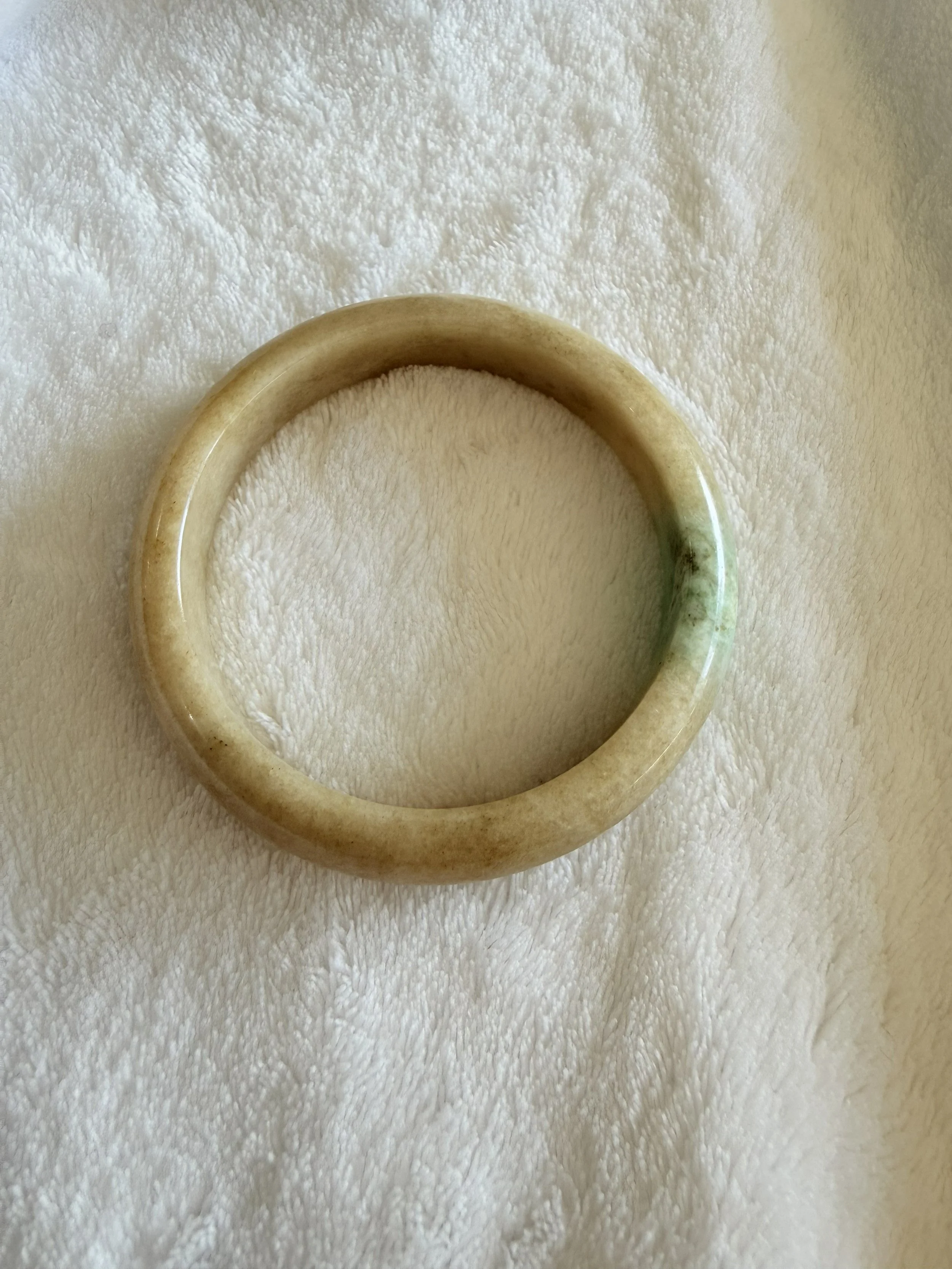 Soft light yellow with gentle spicy green floating.  Natural Burmese Jadeite (58mm)