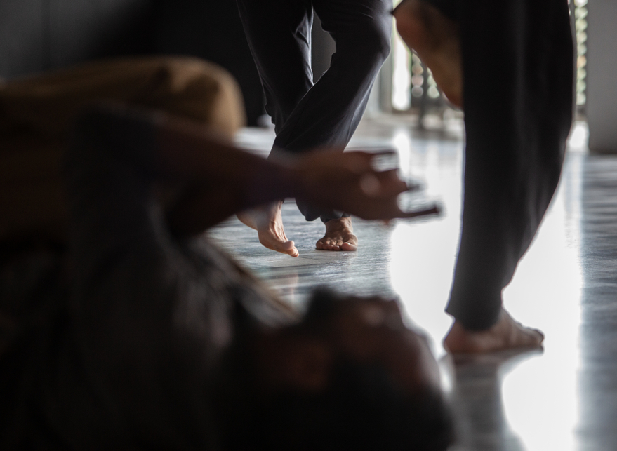 Close up of people's legs dancing and moving in a dance studio.