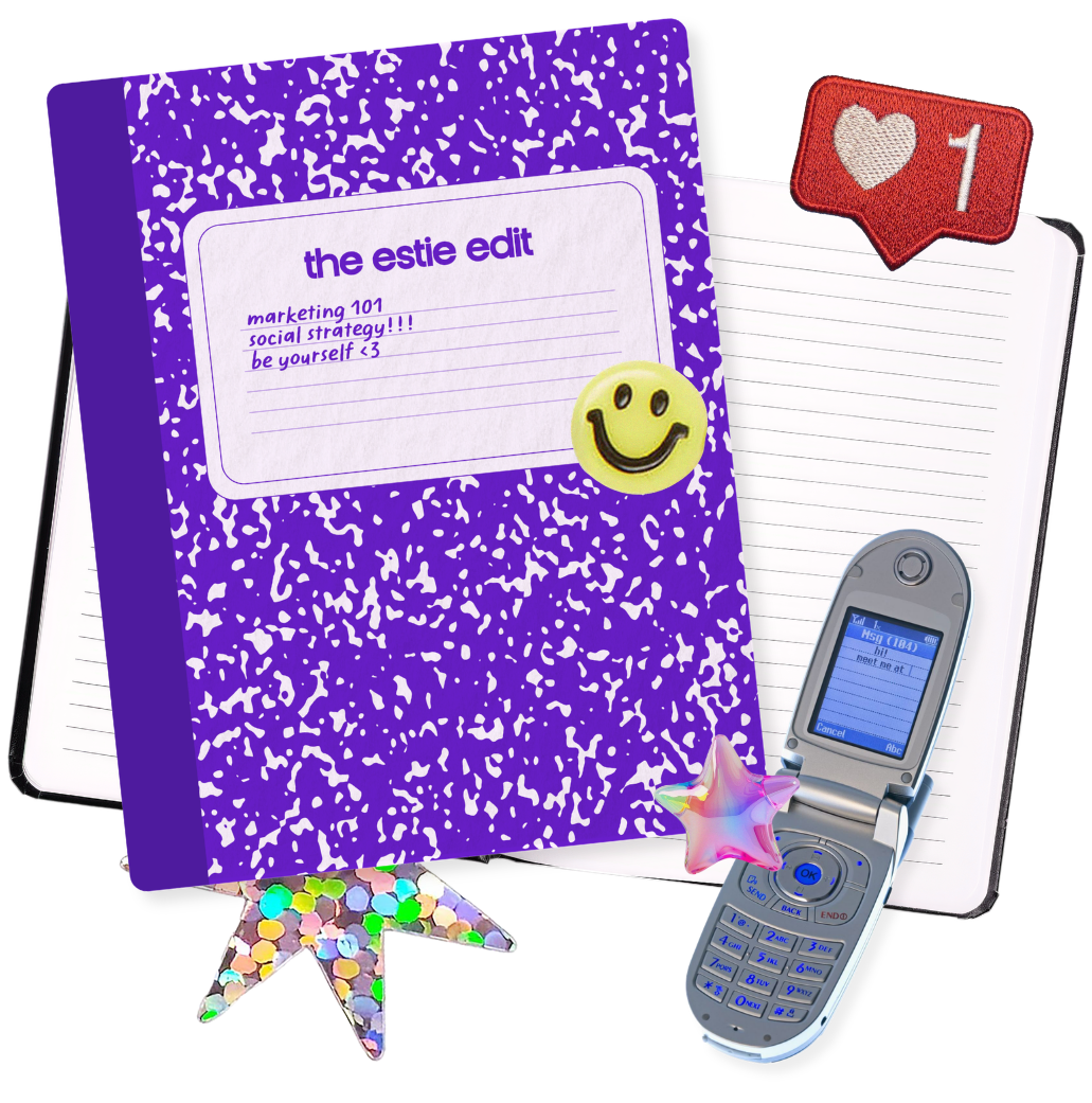 A purple notebook titled 'the estie edit' with handwritten notes and a yellow smiley face sticker. Surrounding the notebook are an open lined notebook with a flip phone with a text message, a multicolored star-shaped ornament, a small holographic star, and a 'like' notification with one heart.