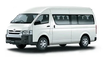 A white passenger van with tinted windows and sliding door, viewed from the side