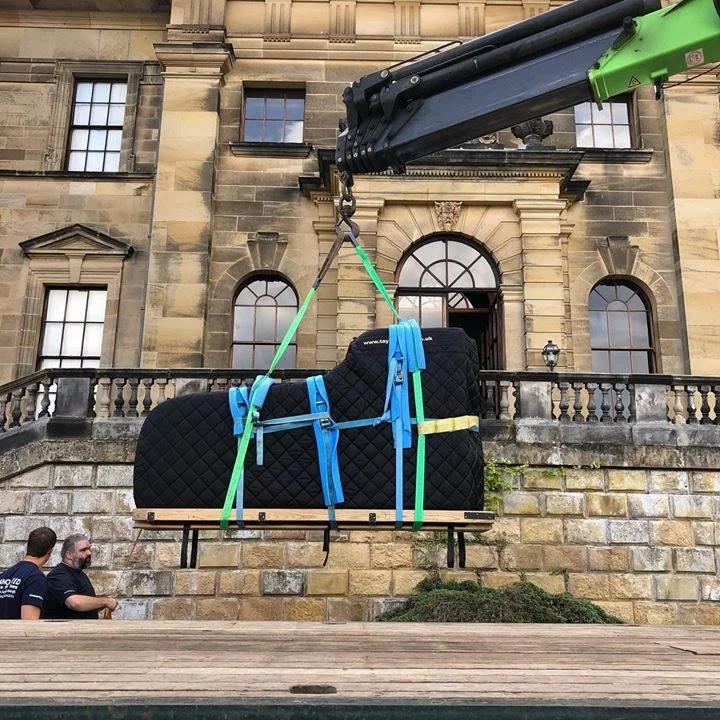 Piano being safely moved into a stately home.
