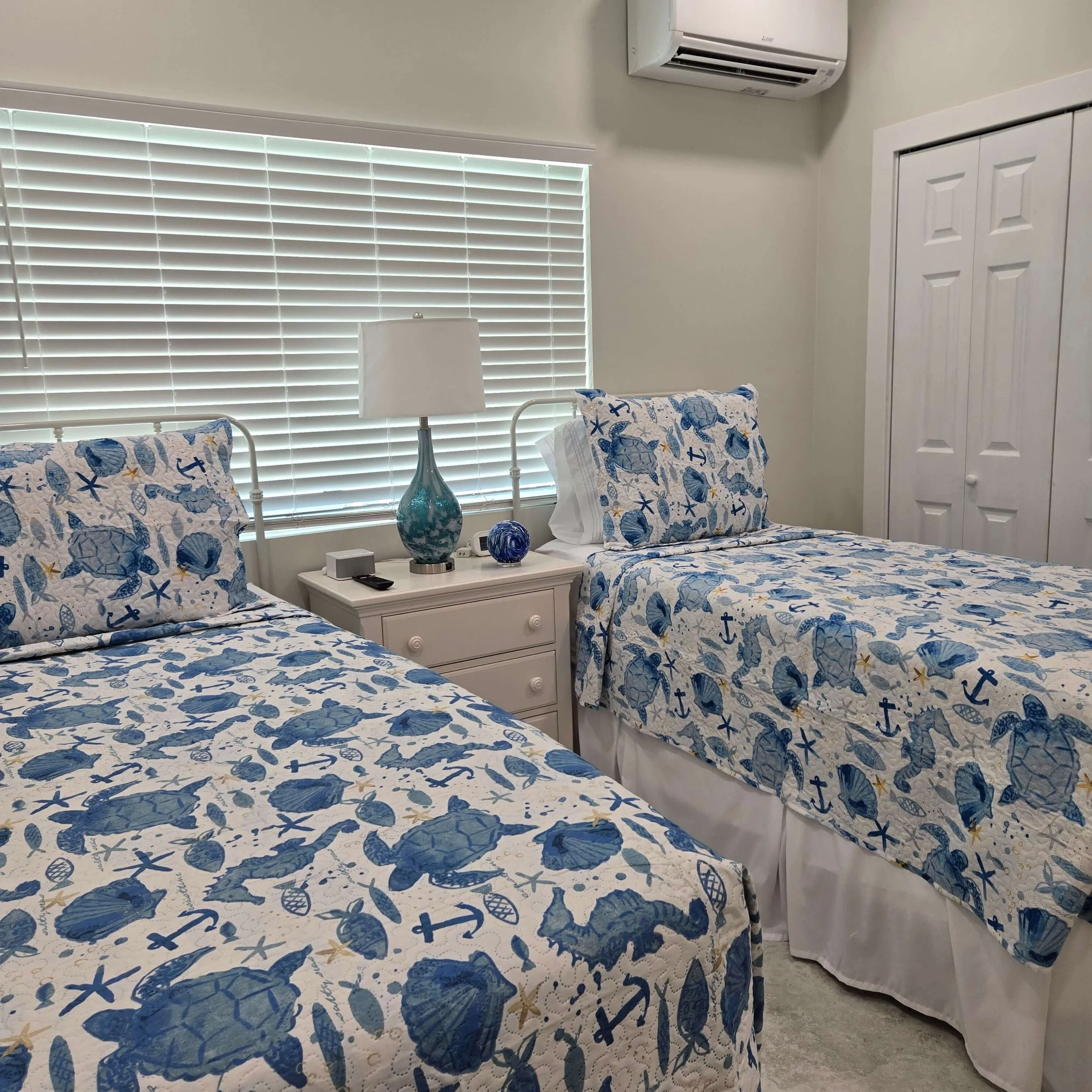 Modern twin bedroom inside Sea Turtle vacation rental in Staniel Cay