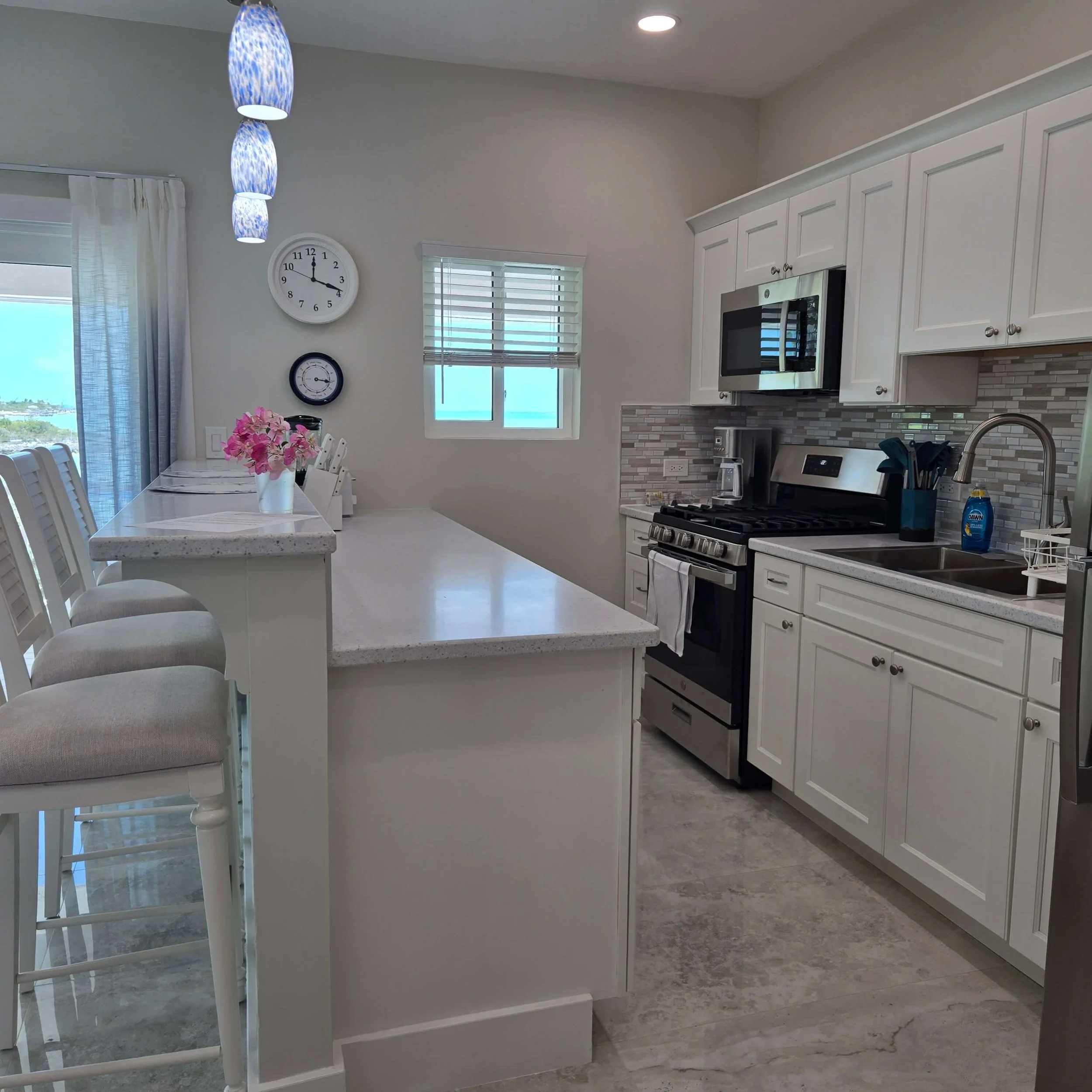 Full kitchen with breakfast bar inside Seaside Vacation Rentals Staniel Cay