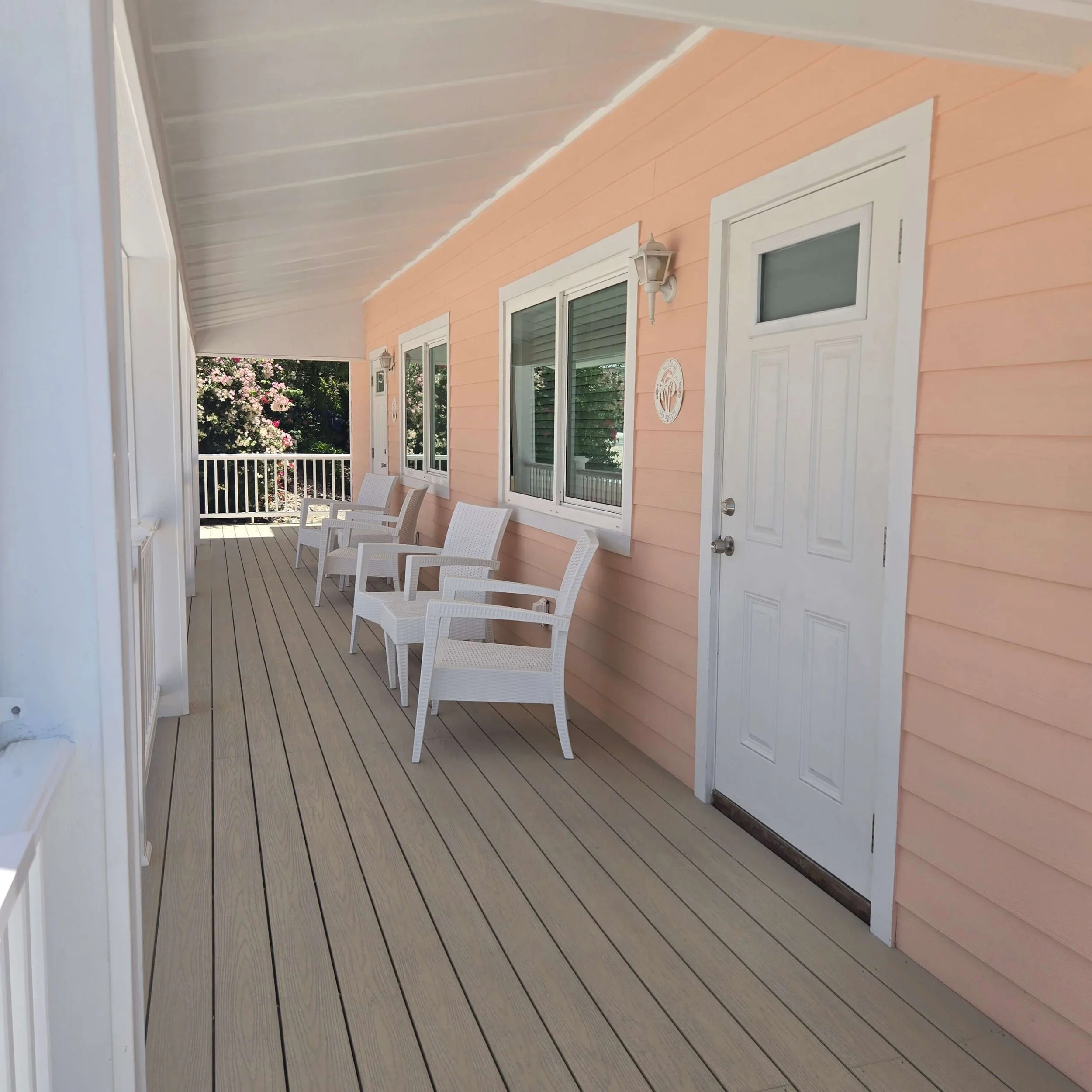 Covered porch with seating outside a Seaside vacation rental in Staniel Cay