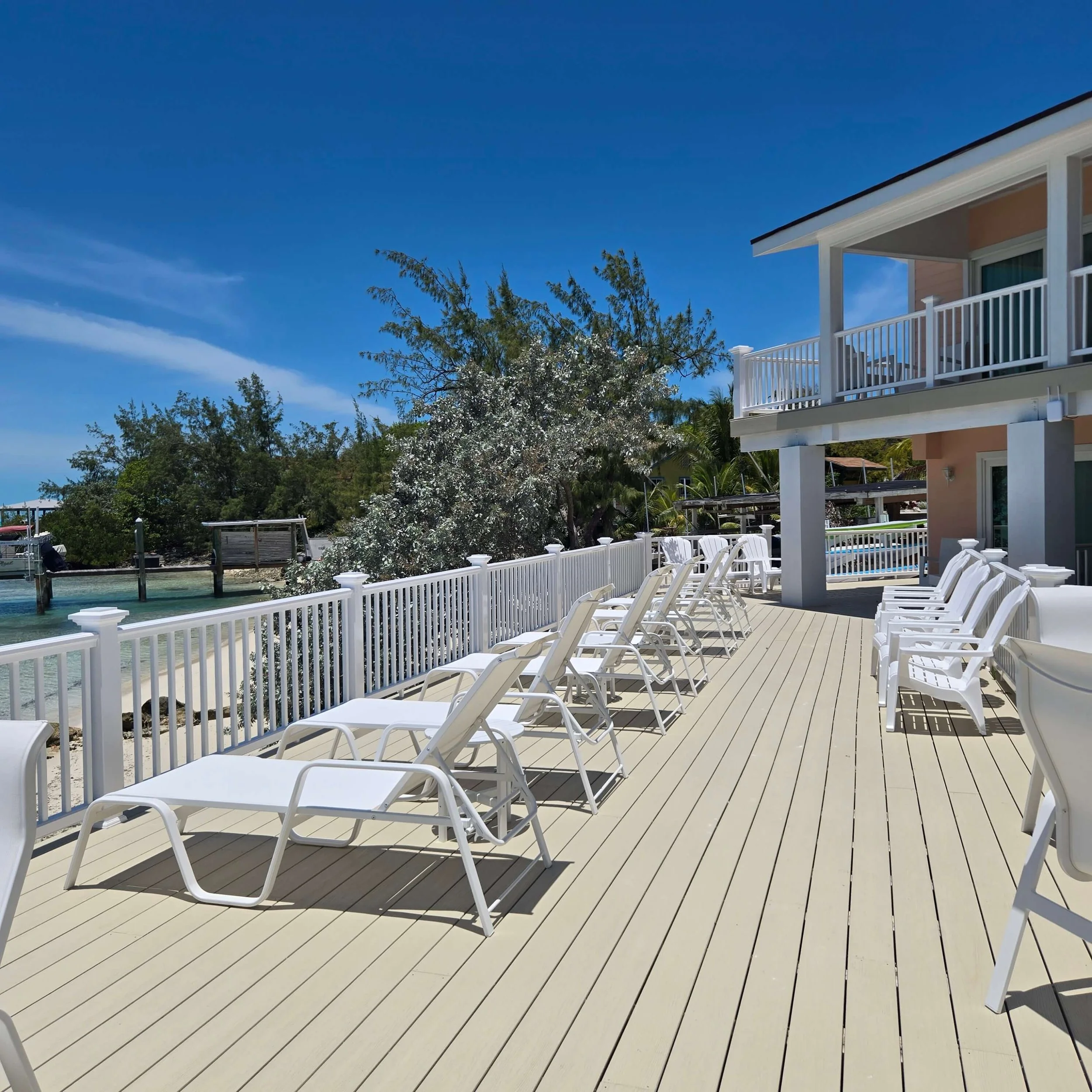 Seaside's oceanfront deck with white lounge chairs