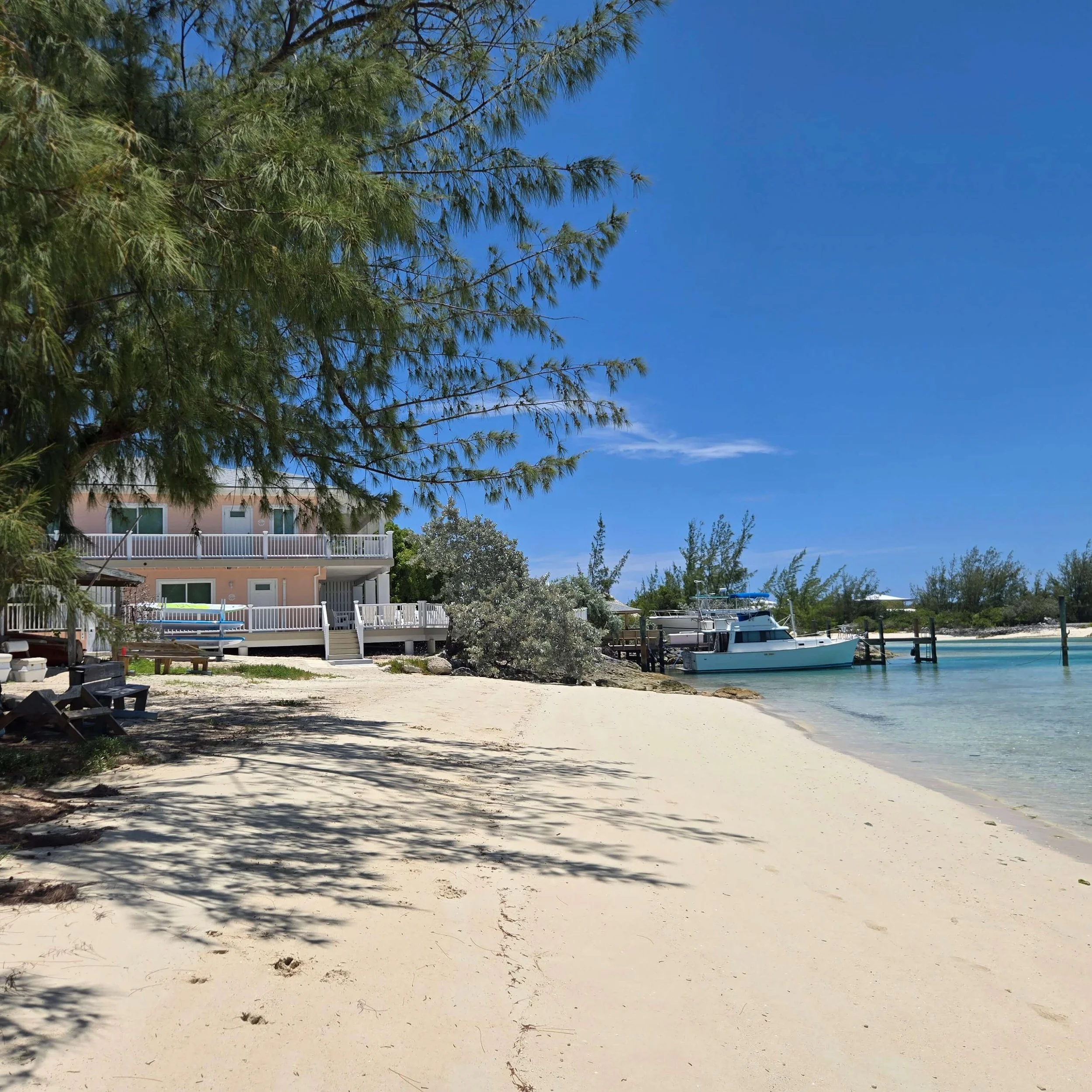 The sandy beach and clear ocean outside Staniel Cay Seaside Vacation Rentals
