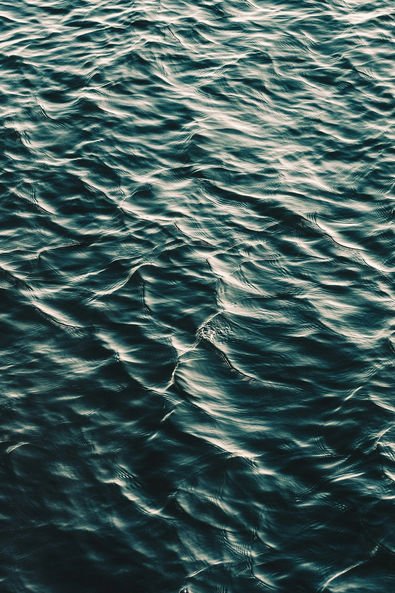 Close-up of ocean water with ripples and waves reflecting light.