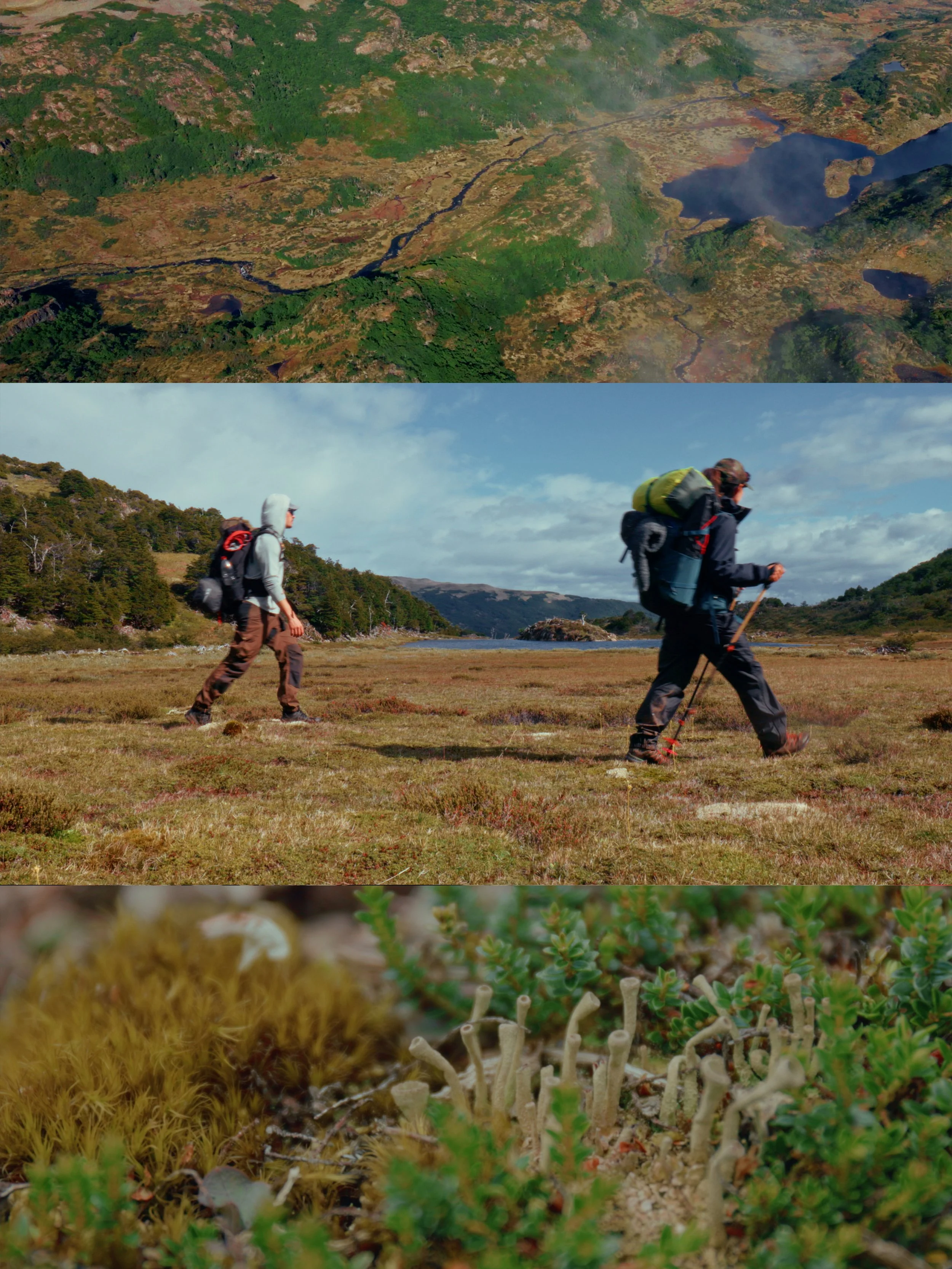 Aerial view of a mountainous landscape with a river, lakes, and diverse vegetation including patches of forest and grassland. Two hikers with backpacks walk across a grassy plain near a lake, under a partly cloudy sky.