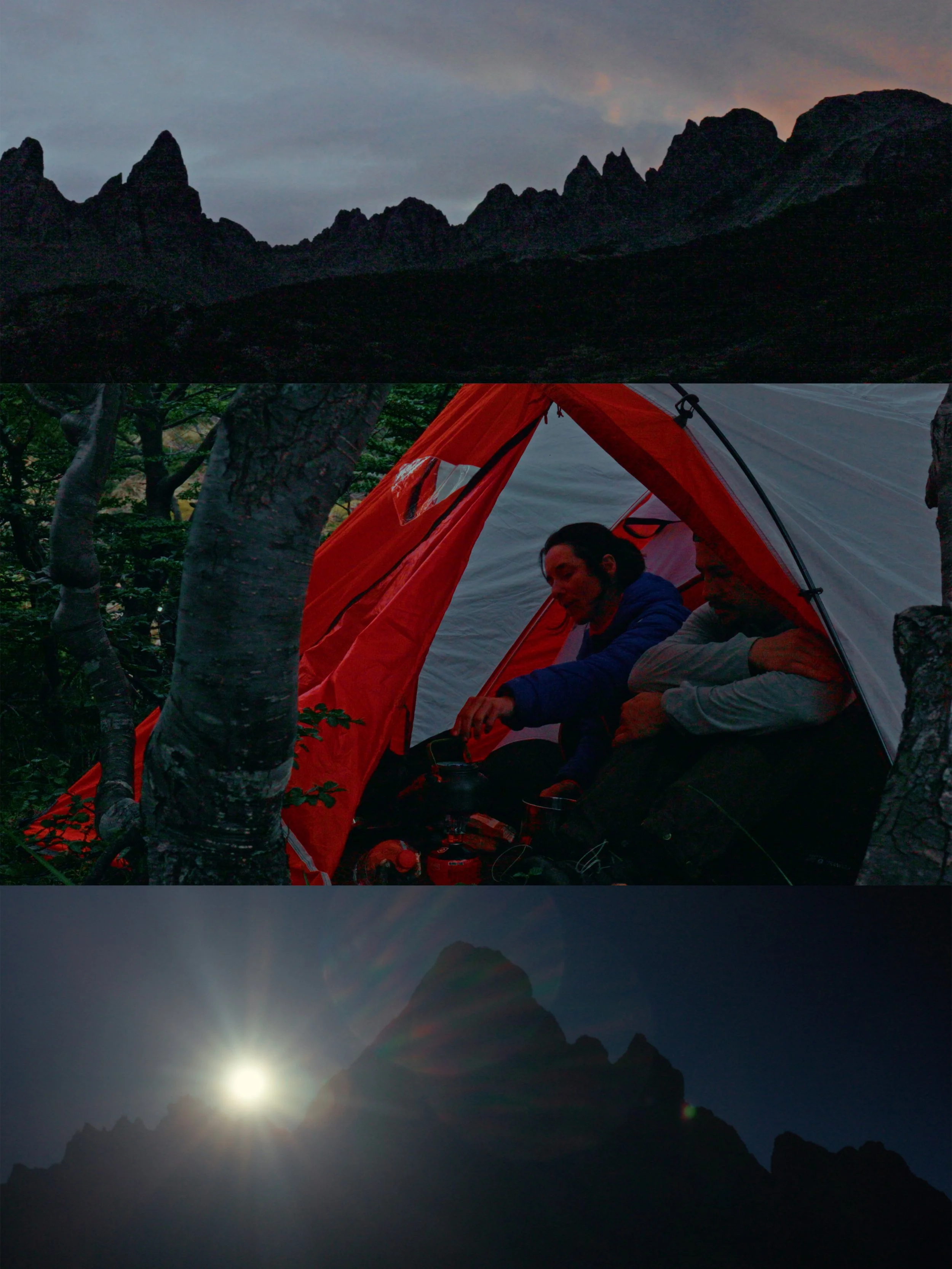 A mountain landscape at sunset or sunrise with a dark silhouette of jagged peaks against a cloudy sky. The bottom part of the image shows a camping scene with two people sitting inside an orange tent among trees, and a distant mountain with the sun e