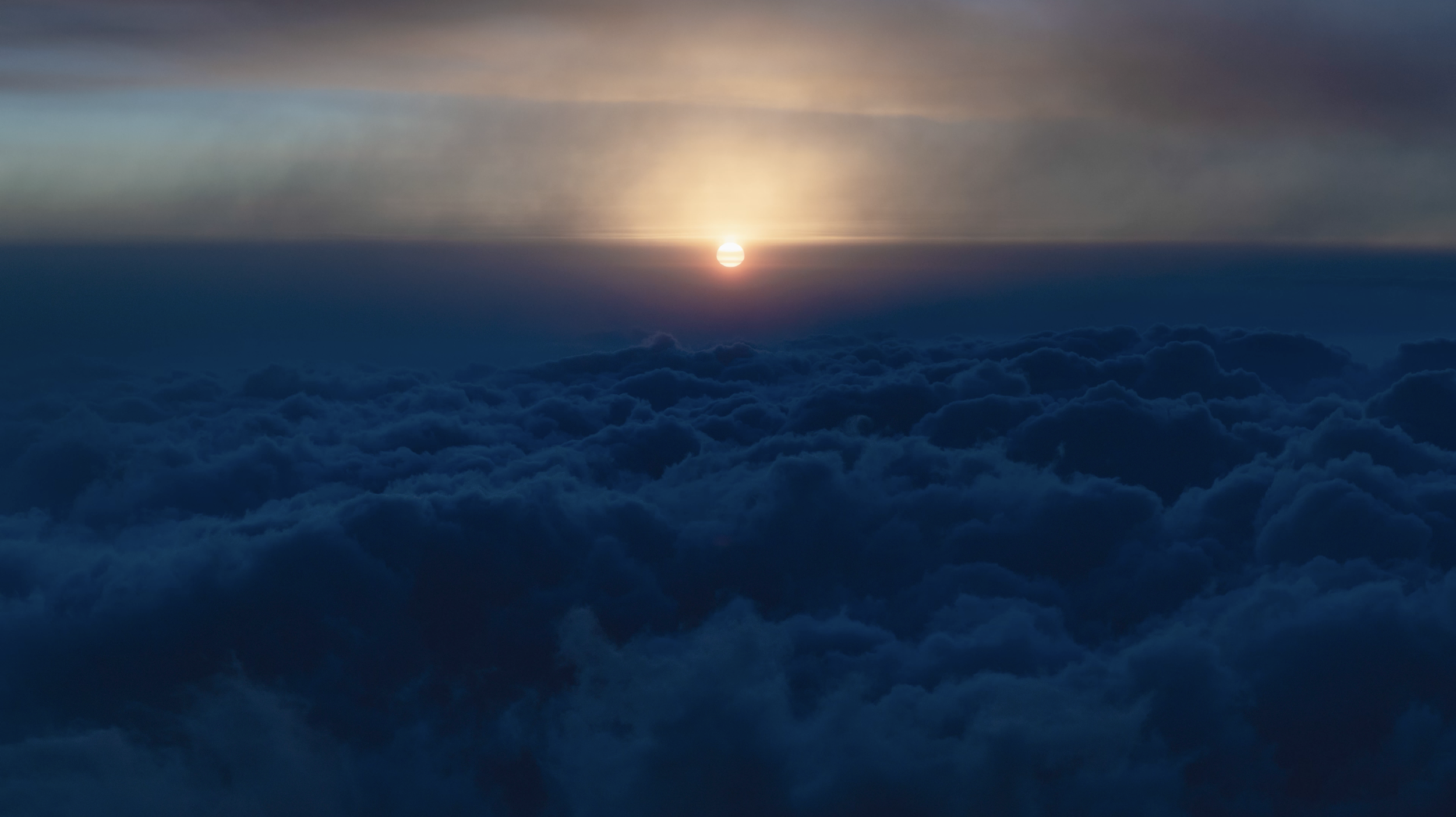Sunset or sunrise above clouds with a gradient sky of warm colors.