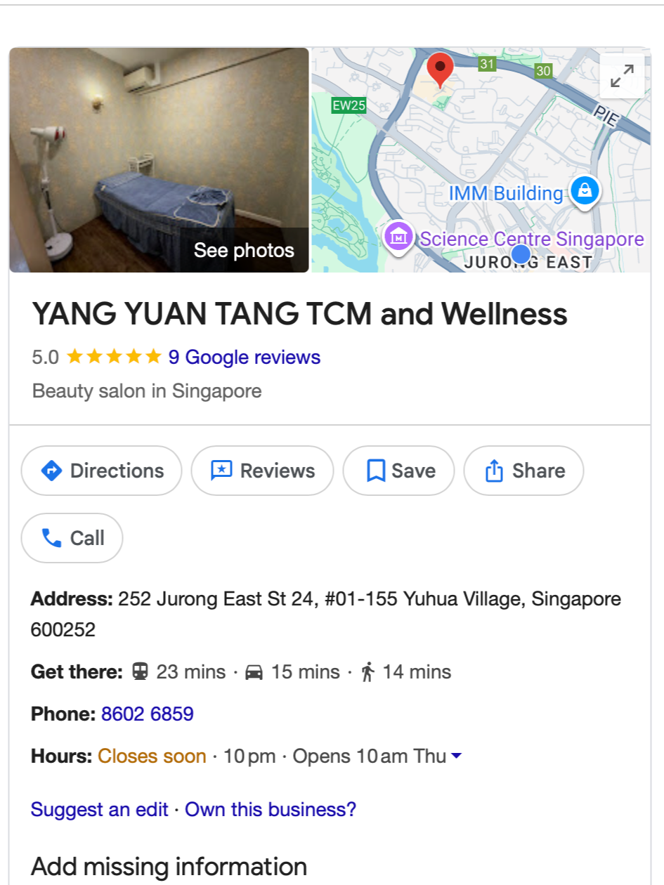 Interior of beauty salon room with a massage bed, fan, wall-mounted air conditioner, and wallpaper.