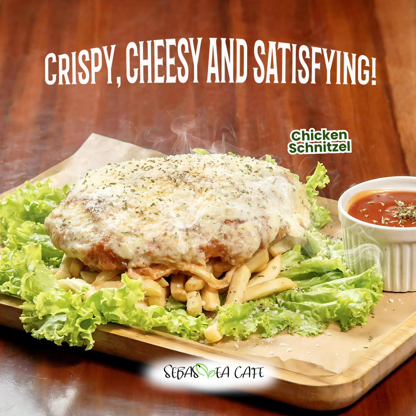 A serving of chicken schnitzel with cheese and herbs, topped with cheese and herbs, served on a bed of French fries, garnished with lettuce, accompanied by a side of tomato sauce in a small white ramekin, on a wooden tray.