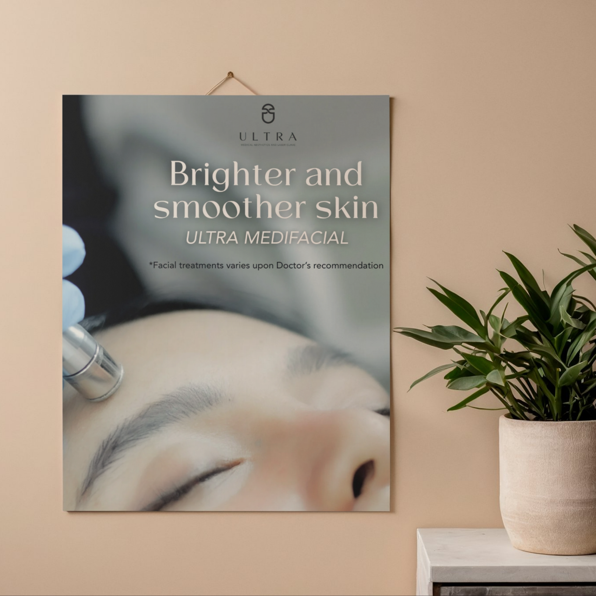 A poster on a beige wall displaying a promotional message for Ultra Medispa, partially visible with a plant on a white stand in the foreground.
