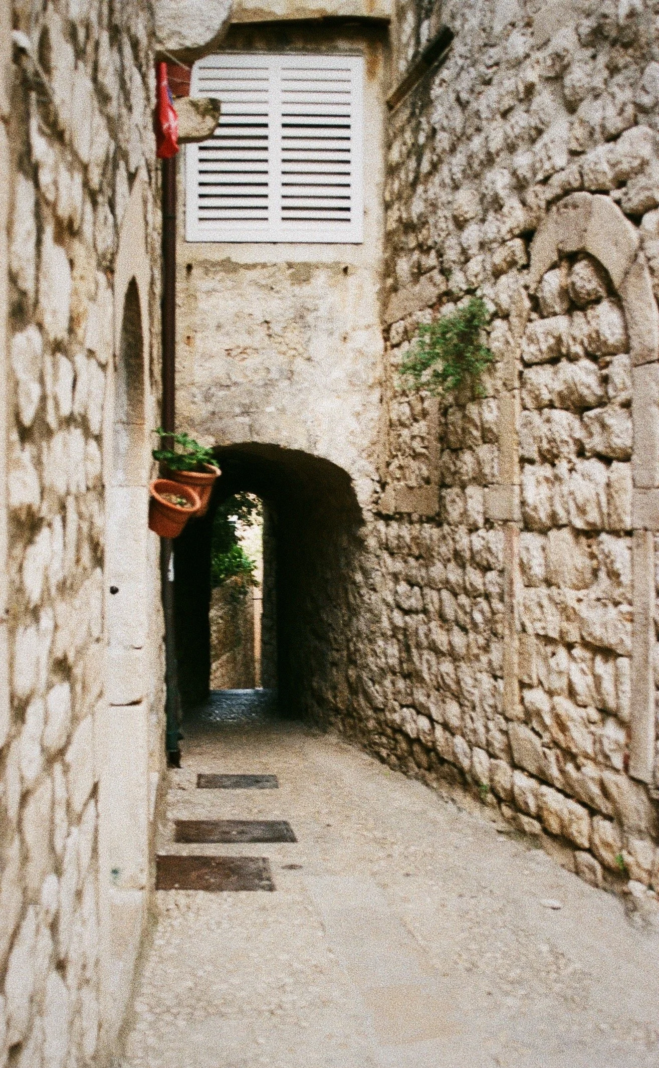 A narrow, stone alleyway in Dubrovnik, Croatia. Analogue. 