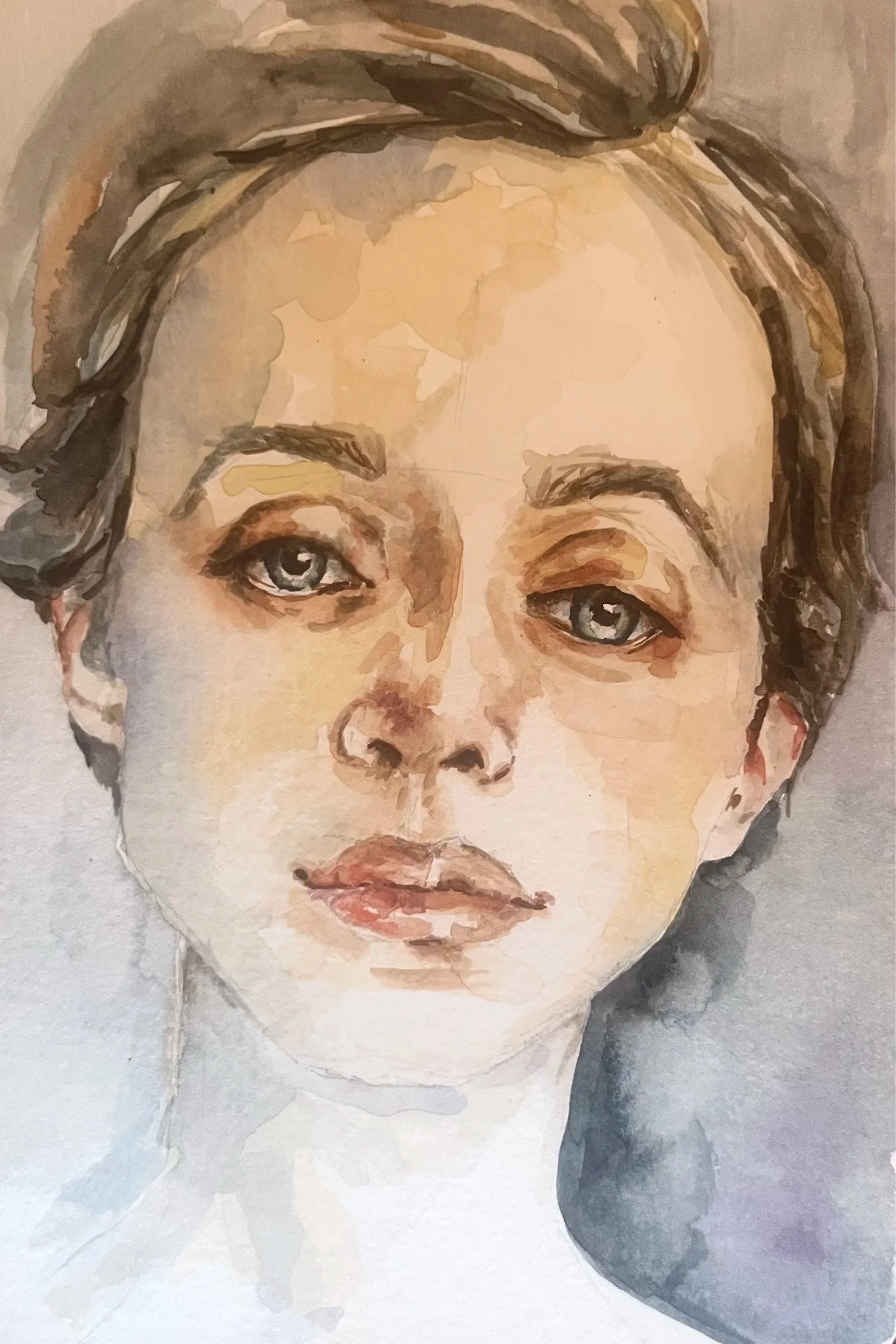 Watercolor painting of a woman's face with blue eyes, light brown hair, and fair skin.