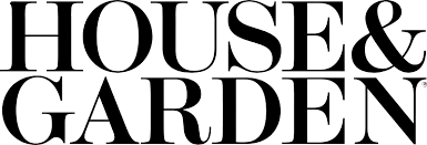 Close-up of a black cat lying on a windowsill at night.