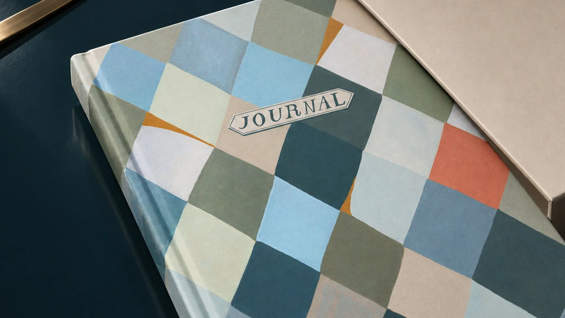 Hand-painted harlequin pattern applied to a boxed journal by Lee Gruber