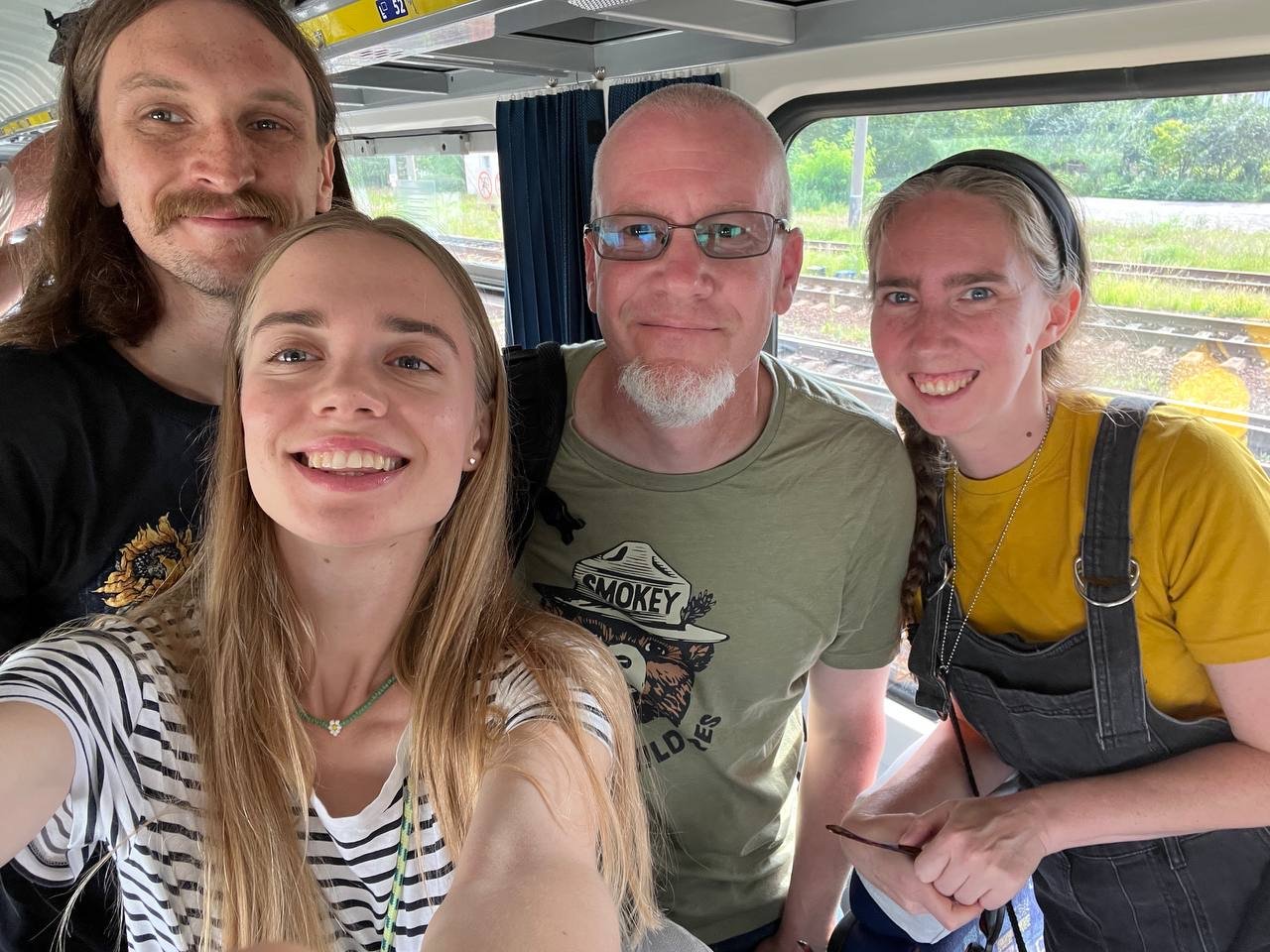UA Ants team members with a visiting US Ants partner on a train in Ukraine, marking the beginning of a collaborative visit.