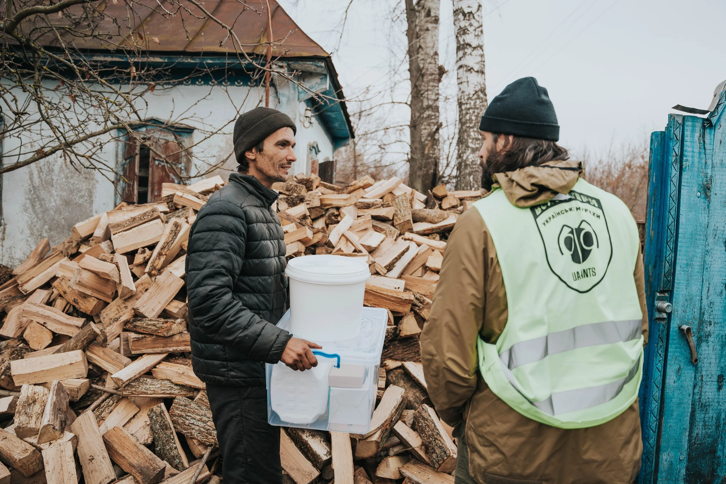 UA Ants team member delivering firewood to a village in Ukraine, providing practical support to families affected by war through US Ants partnership.